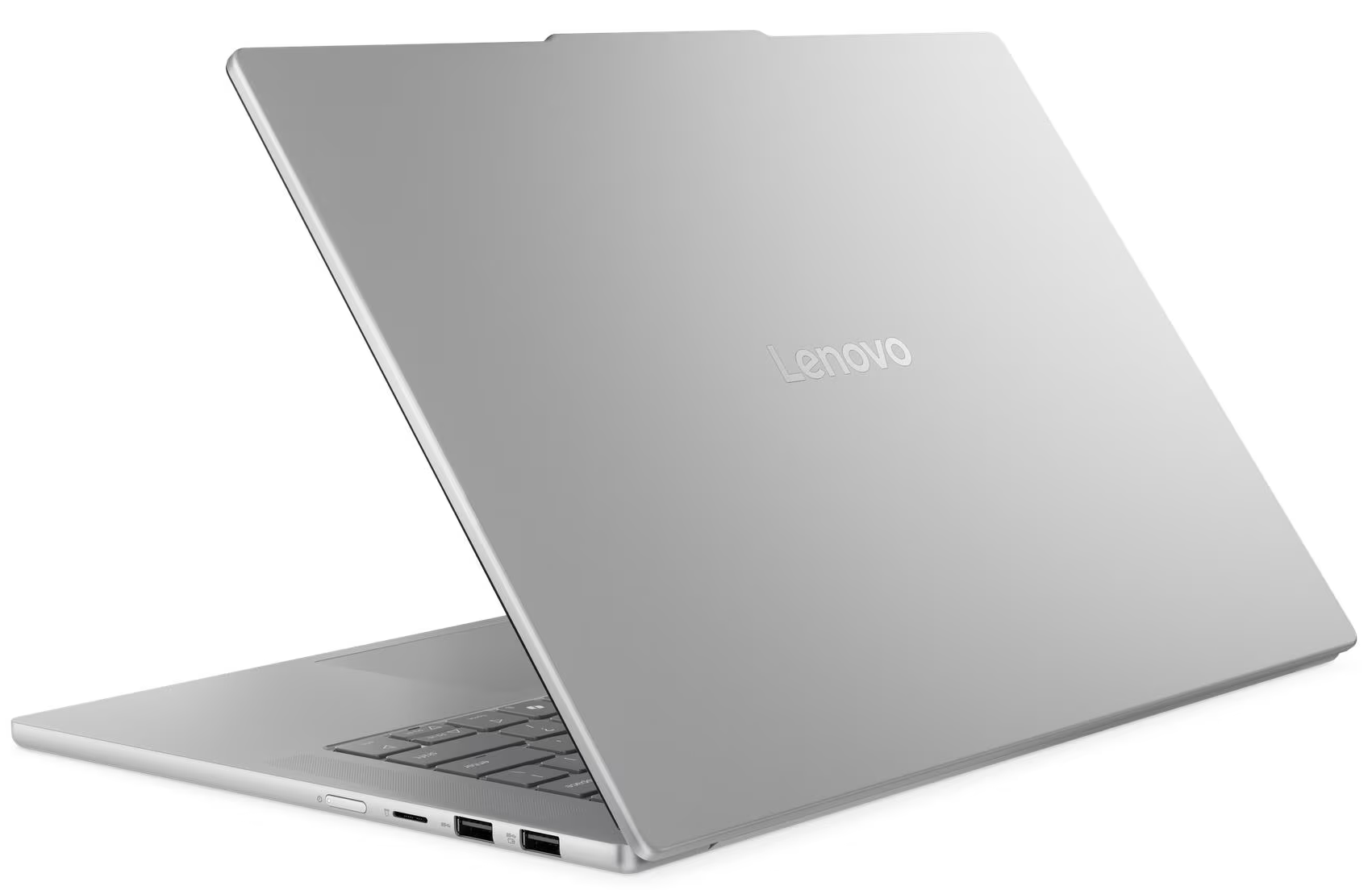 Egy ezüst Lenovo laptop kissé nyitva van. A Lenovo logó látható. A billentyűzet részben látható. A háttér fehér.