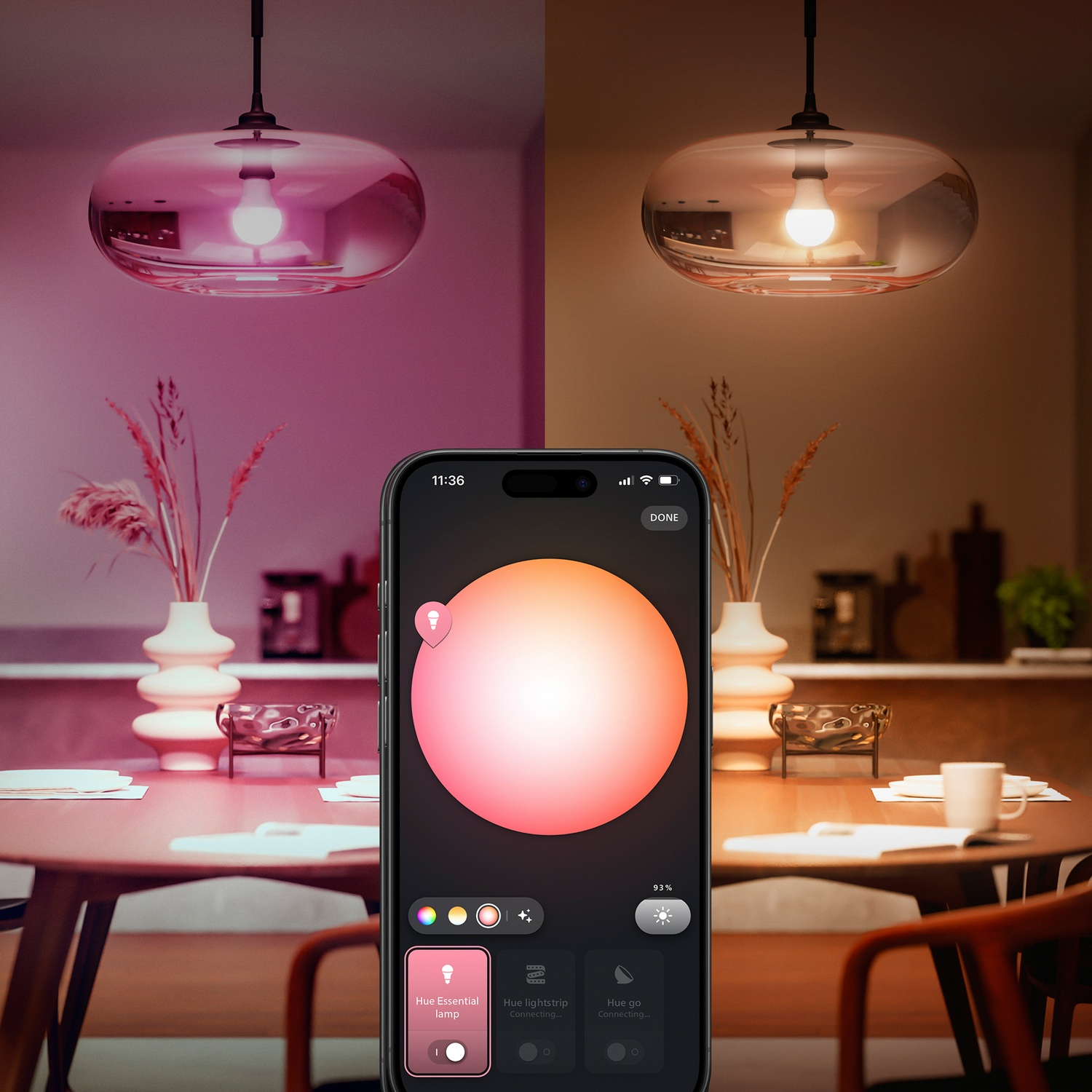 A smart phone controls the color of two pendant lights. One is pink, the other is orange. A table with vases and a bowl is in the scene.