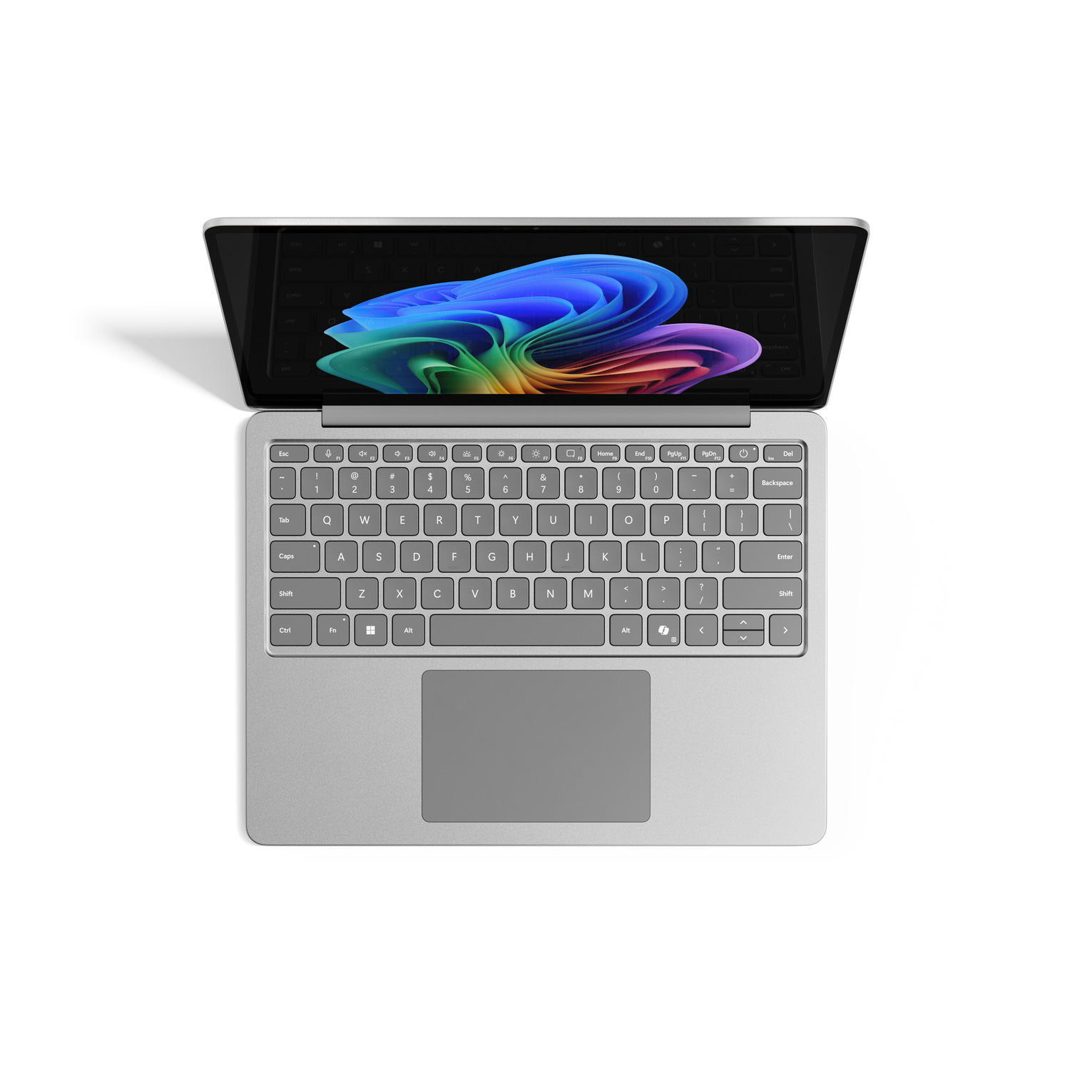 Un portátil con la pantalla abierta que muestra una imagen abstracta colorida. El teclado es visible y el portátil está sobre una superficie gris.