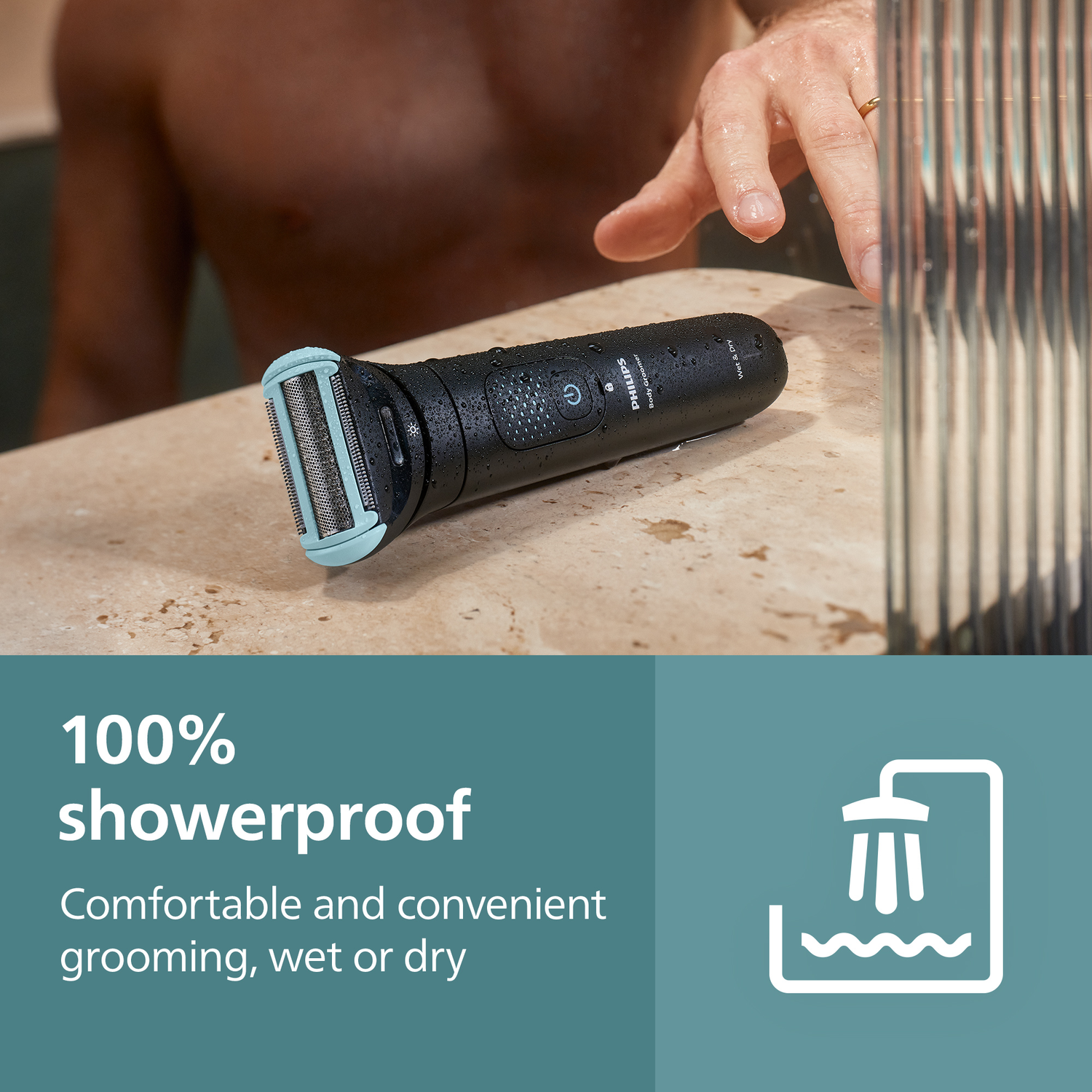 Black Philips body groomer on a wet surface. A man's hand is visible, near a shower. Text: 100% showerproof, wet or dry grooming.