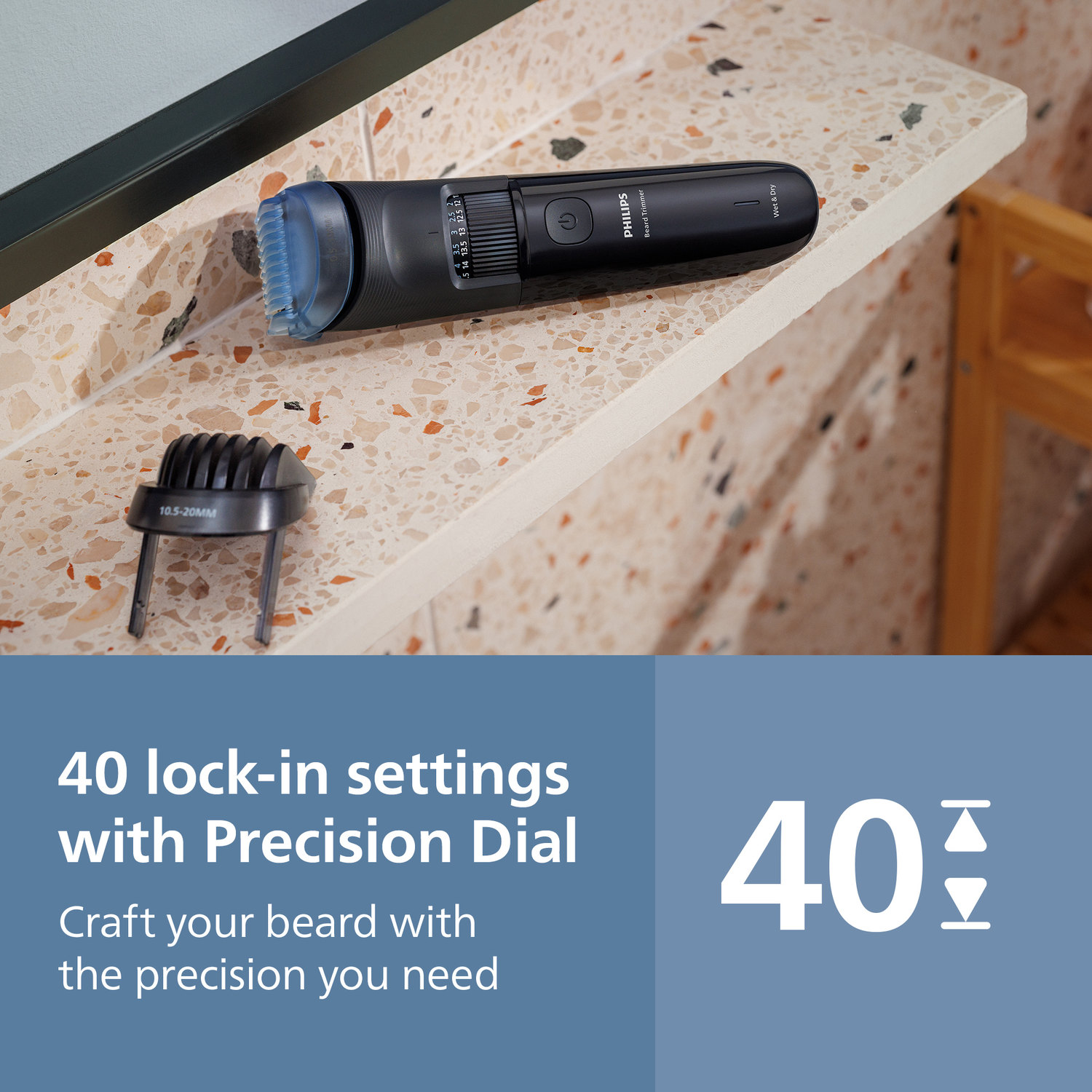 A black Philips beard trimmer with blue head and comb, settings dial. A separate comb, and text on settings.