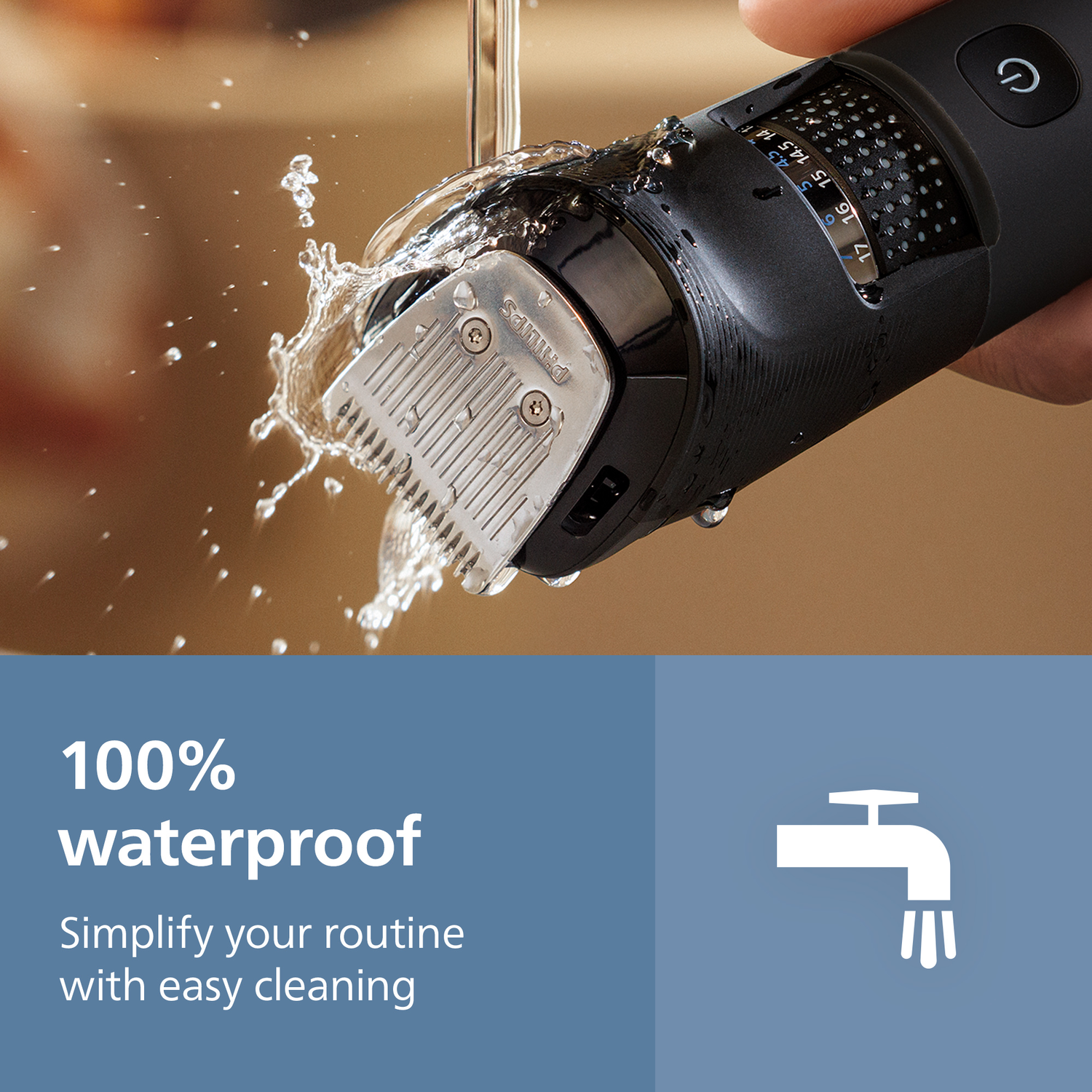 A black Philips beard trimmer being rinsed with water. The trimmer is partially submerged, and water is splashing onto it. Text: 100% waterproof.