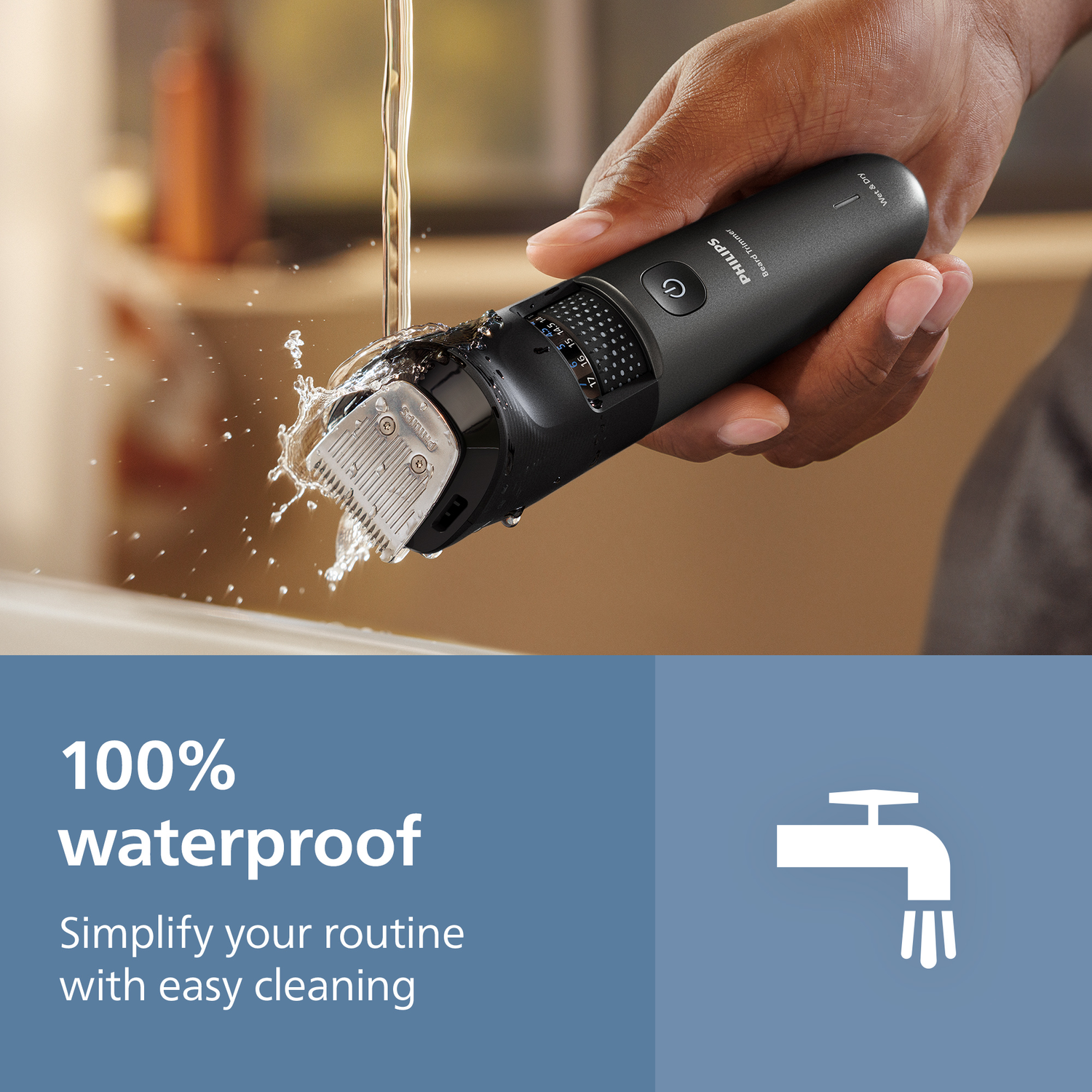 A black Philips beard trimmer being rinsed with water. The image shows the trimmer and water droplets. Text: 100% waterproof, easy cleaning.