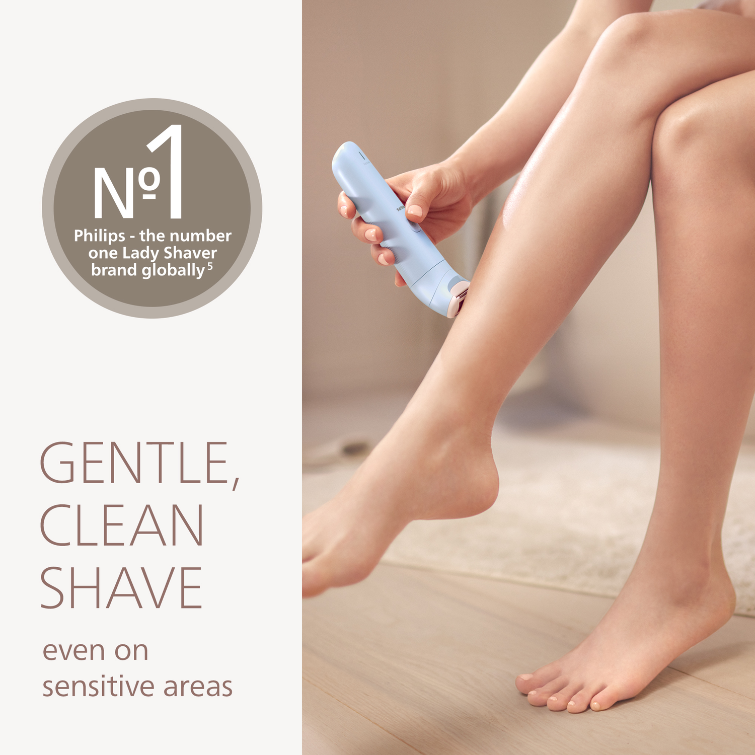 A woman shaves her leg with a blue Philips shaver. The image shows a close-up of the woman's legs and the shaver.