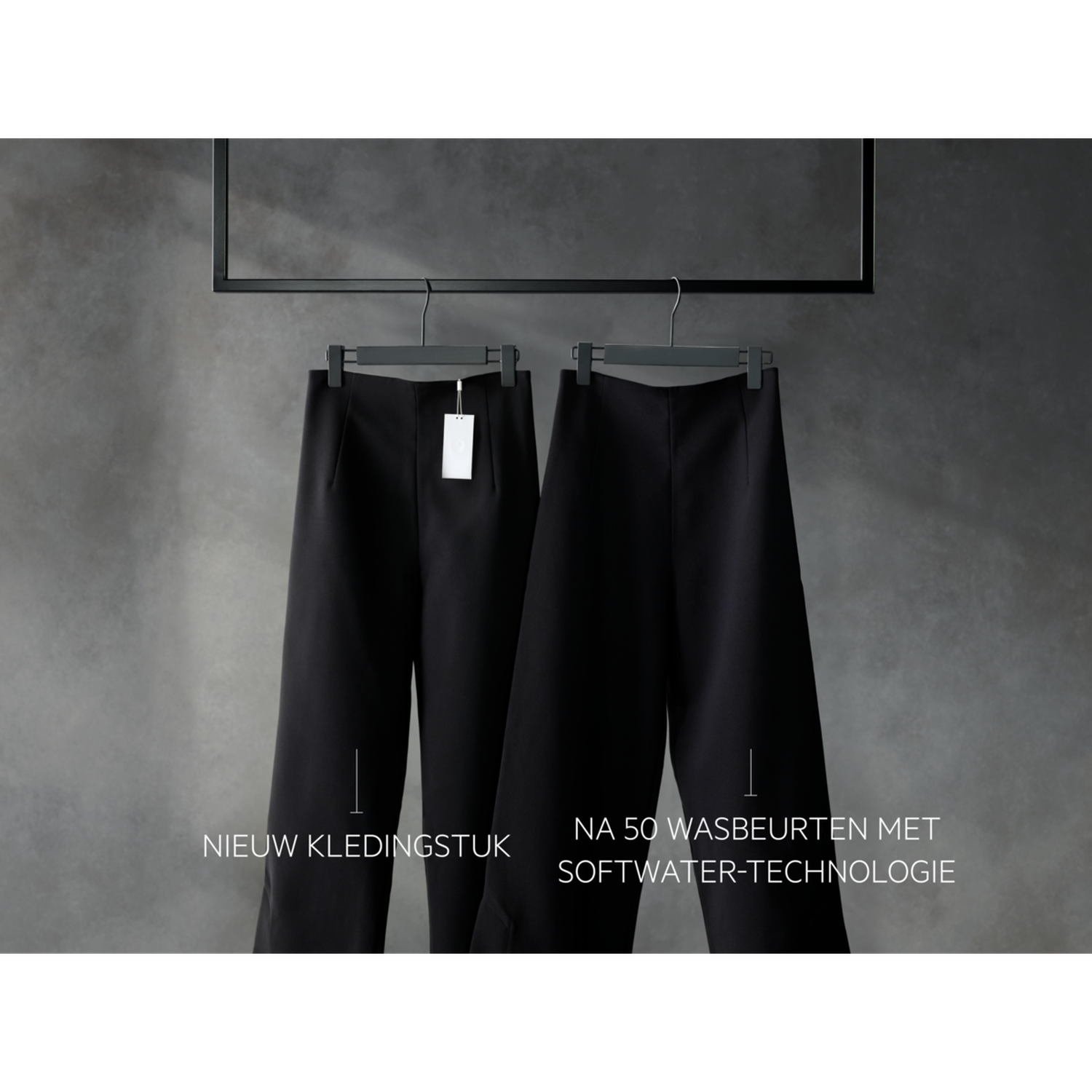 Two black pants hanging on hangers. Tag on one. Text at the bottom. One says 'New garment'. The other says 'After 50 washes'.