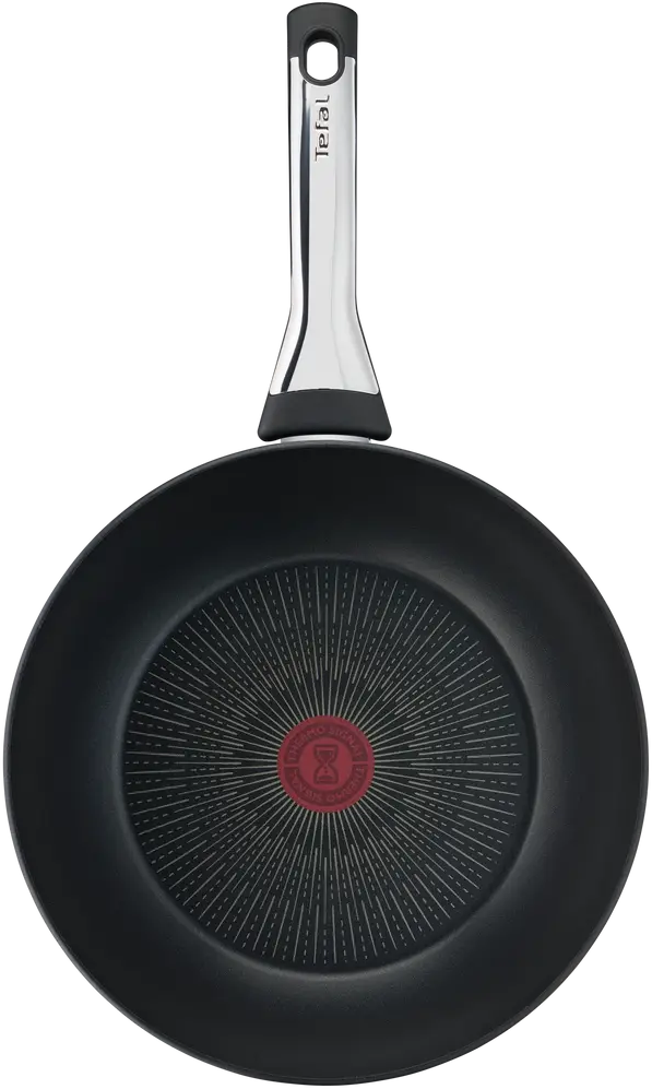 Una padella Tefal nera. Ha un manico argentato con il logo Tefal. Il fondo ha un cerchio rosso Thermo-Signal.