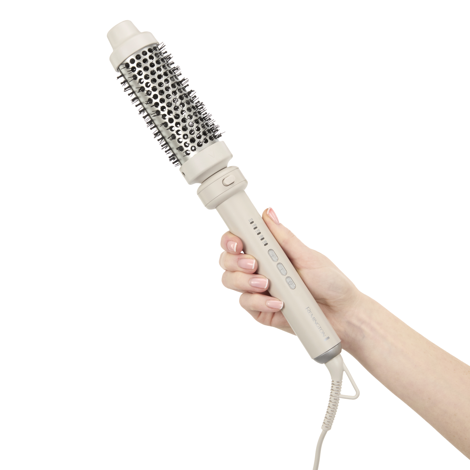 A woman's hand holds a beige Remington hair styling brush. The brush has a round head with bristles and a handle with buttons.