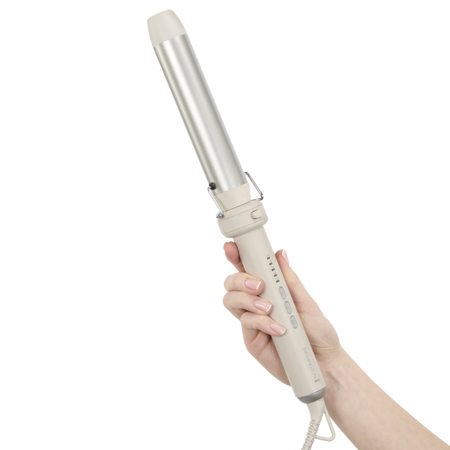A woman's hand holds a curling iron against a white background. The iron is silver and beige. The woman has manicured nails.