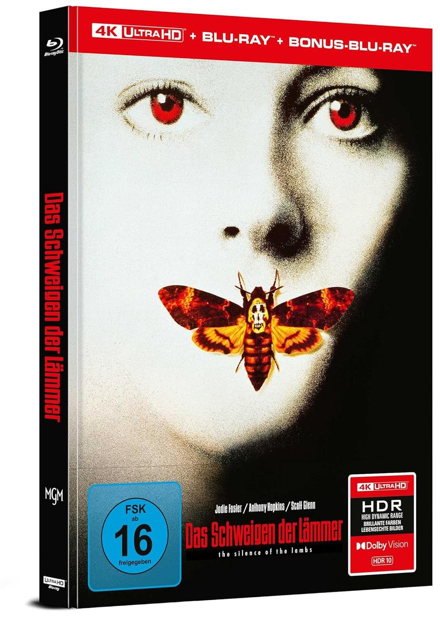 DVD-Cover von Das Schweigen der Lämmer. Im Hintergrund das Gesicht einer Frau, davor eine Motte. Titel auf Deutsch.