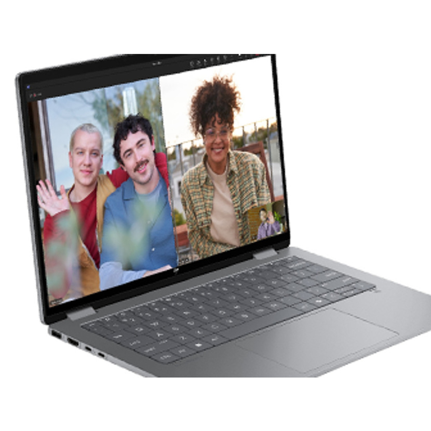 Laptop screen shows a video call with three people. One waves. Laptop is silver, keyboard visible.