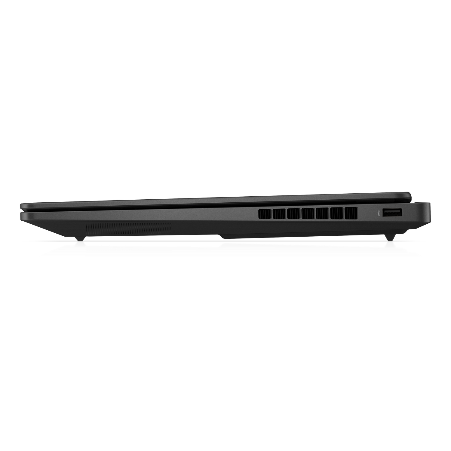 Side view of a closed, dark gray laptop on a white surface. Visible are vents, USB ports, and the edge of the laptop.