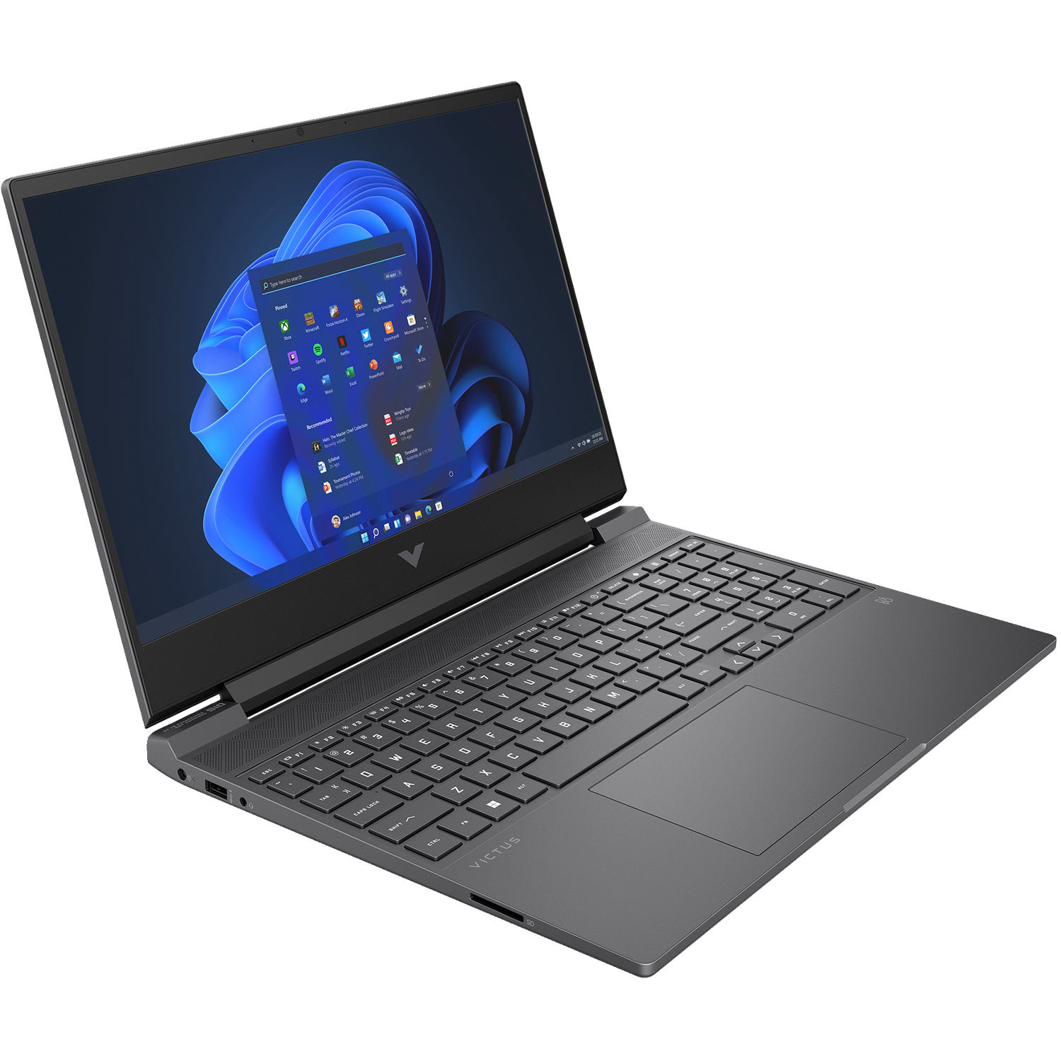 A black HP Victus laptop is open, displaying the Windows 11 desktop. The screen shows app icons and a search bar, keyboard visible.