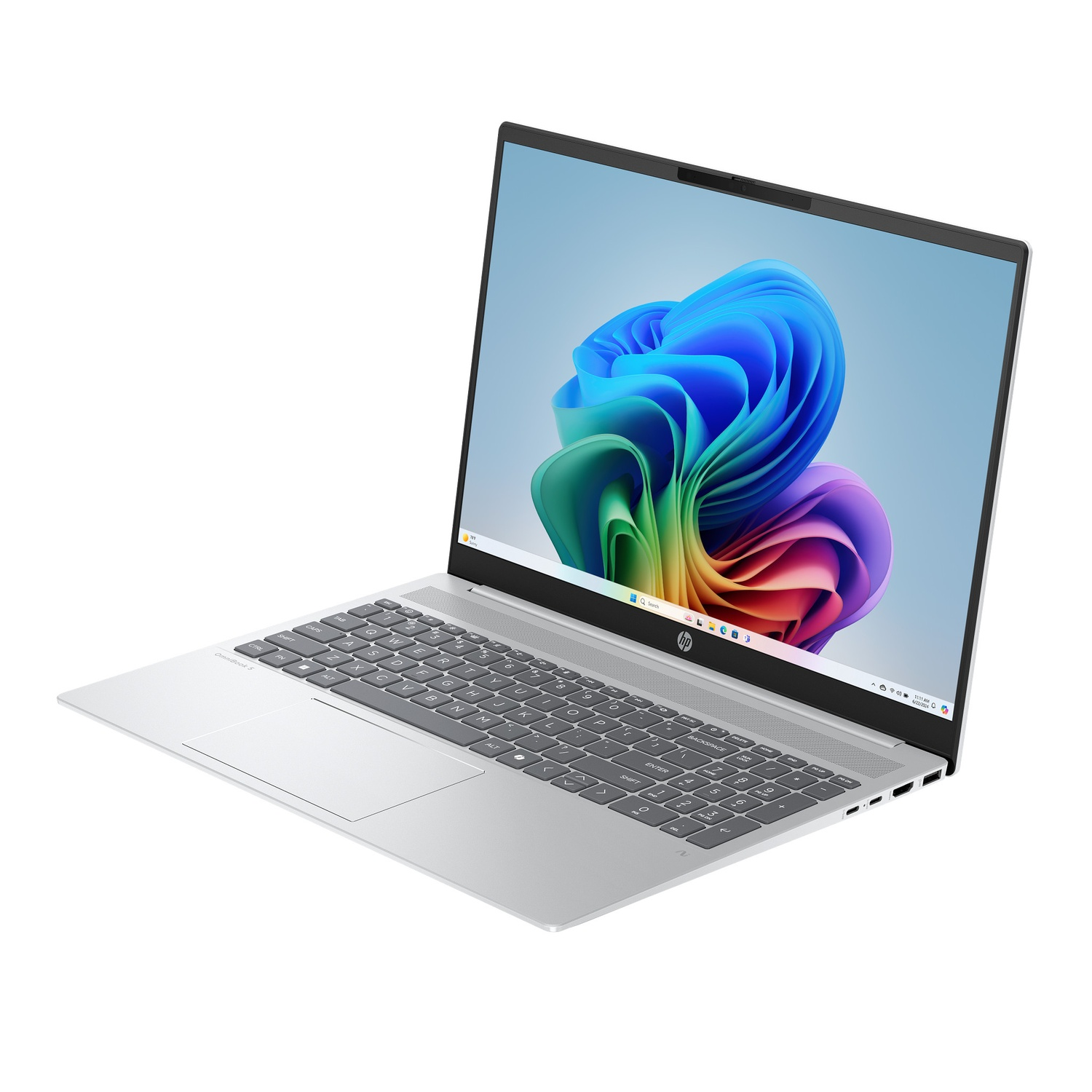 A silver HP laptop is open, showing a colorful abstract image on the screen. The keyboard is visible, and the laptop is on a white surface.