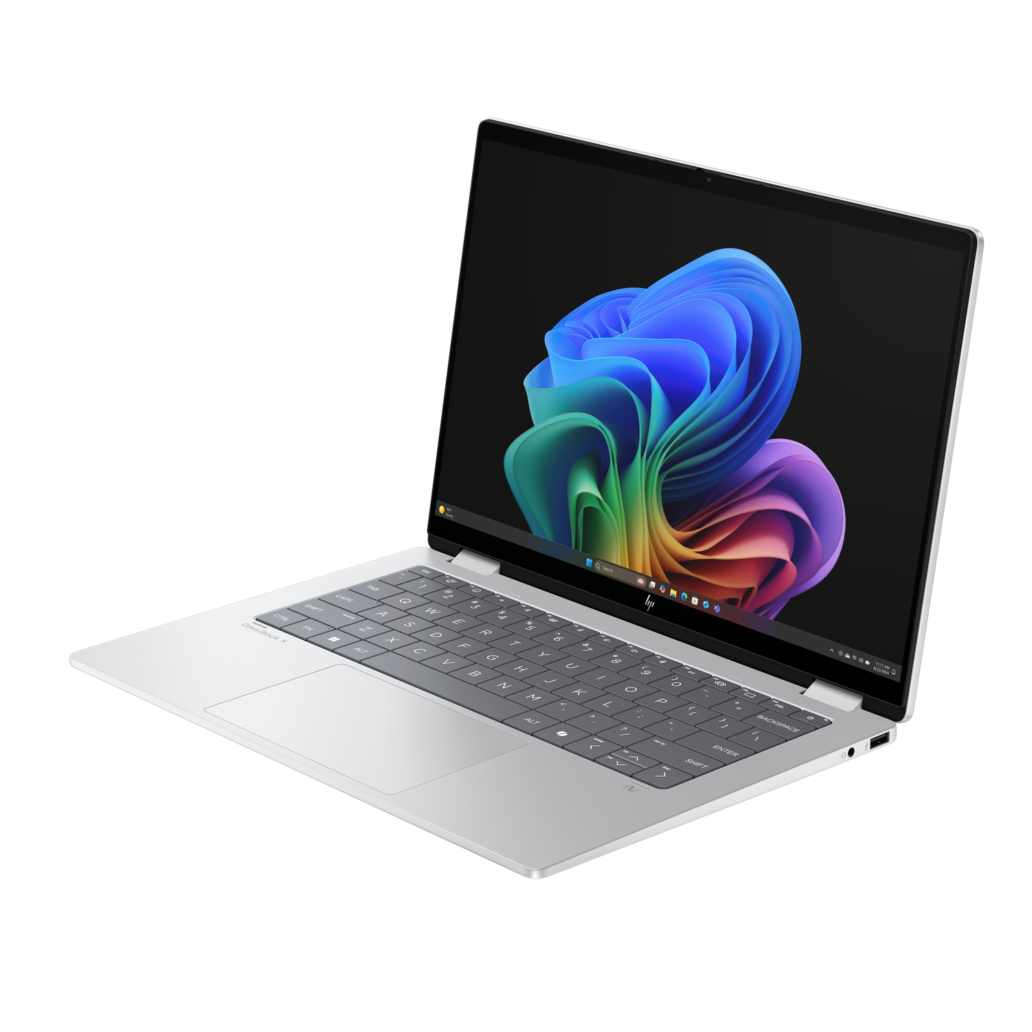 Silver laptop with a colorful abstract wallpaper is open on a black surface. Keyboard is visible. The screen shows a colorful swirl.