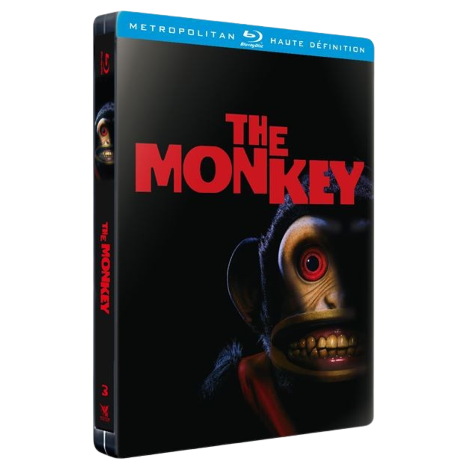 DVD-hoes voor 'The Monkey'. Het toont een eng apengezicht met rode ogen en grote tanden tegen een zwarte achtergrond.