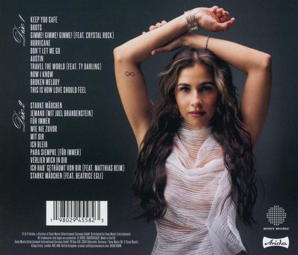 Eine Frau mit langen Haaren und weißem Oberteil posiert mit über dem Kopf erhobenen Armen. Titelliste des Albums links. Sony Music Logo rechts.