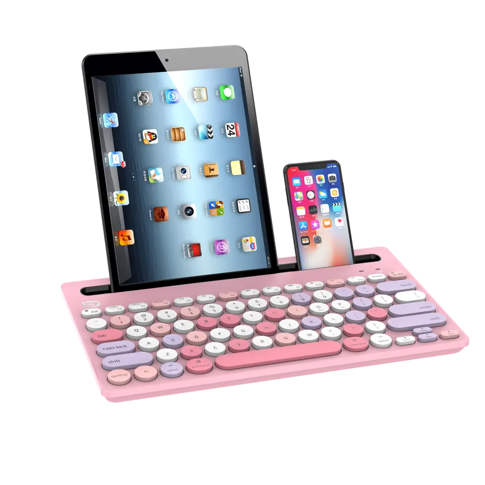 Pembe klavye, tablet ve telefon. Tablet ve telefon klavyede duruyor. Tuşlar beyaz, pembe ve mor.