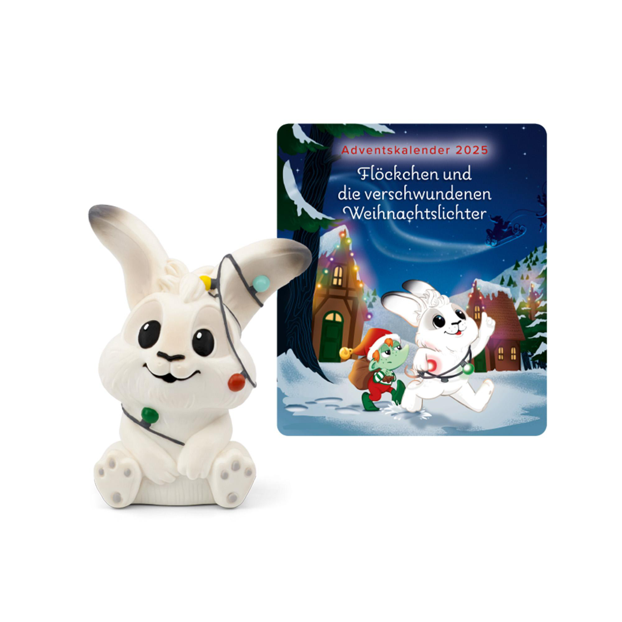 Eine weiße Hasenfigur mit Weihnachtsbeleuchtung neben einer Adventskalender-Illustration eines Hasen und eines Elfen.