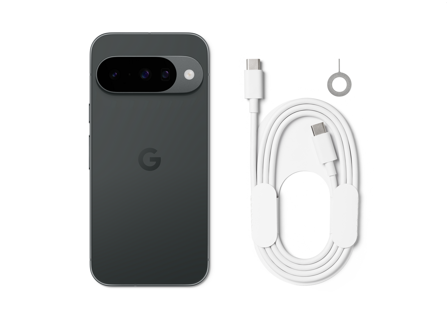Un teléfono Google Pixel gris oscuro, cable USB-C blanco, herramienta de expulsión de SIM, sobre fondo blanco. El teléfono tiene cámaras y el logotipo de Google.