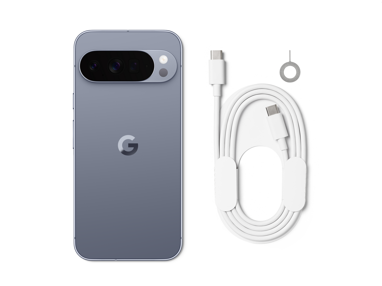 Un teléfono Google Pixel gris con barra de cámara y logo 'G', cable USB-C, herramienta de expulsión SIM, todo sobre fondo blanco.