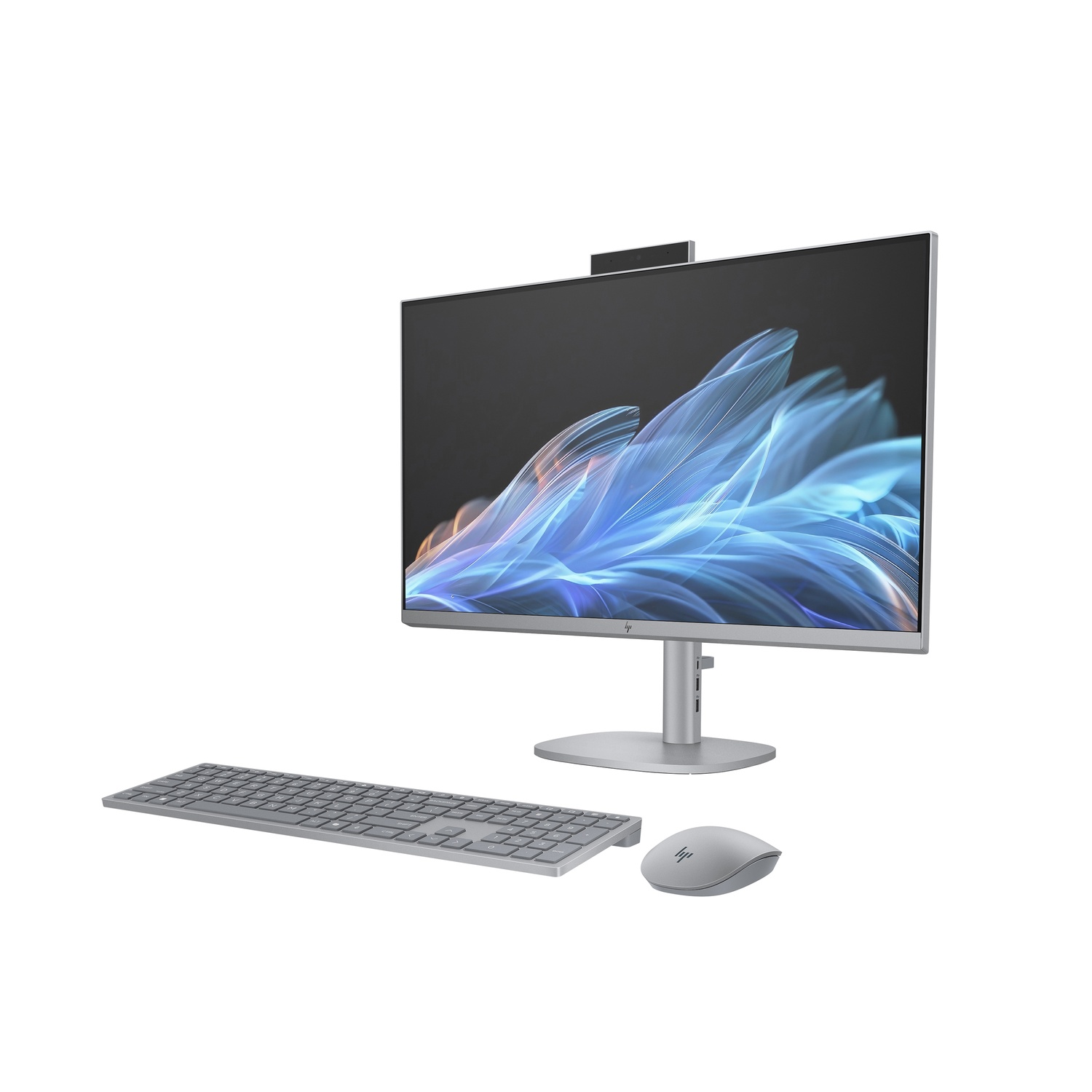 A silver HP all-in-one computer with a keyboard and mouse. The screen displays blue and white abstract art on a black background.