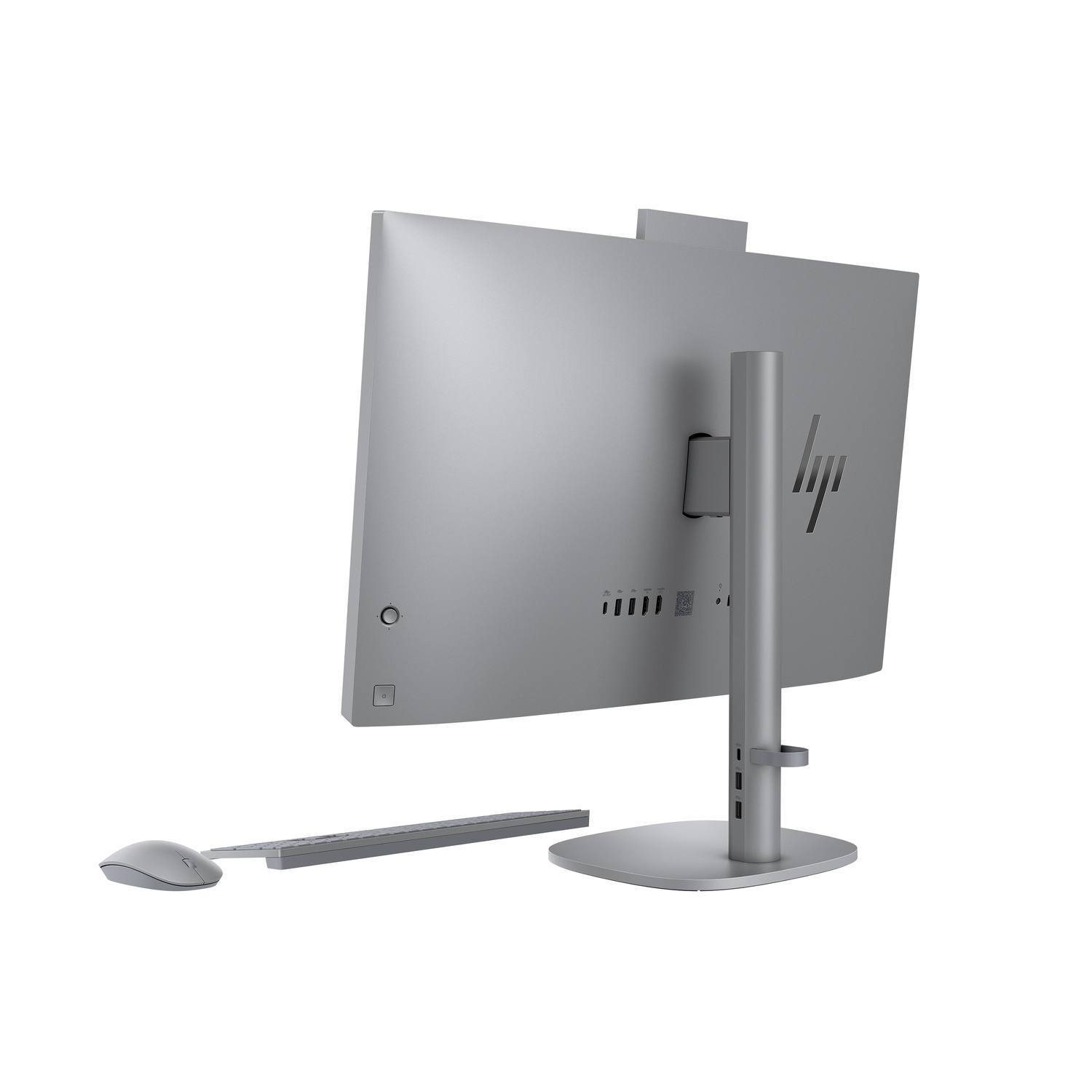 Rear view of a silver all-in-one computer. A mouse and keyboard are in the foreground. The HP logo is on the monitor.