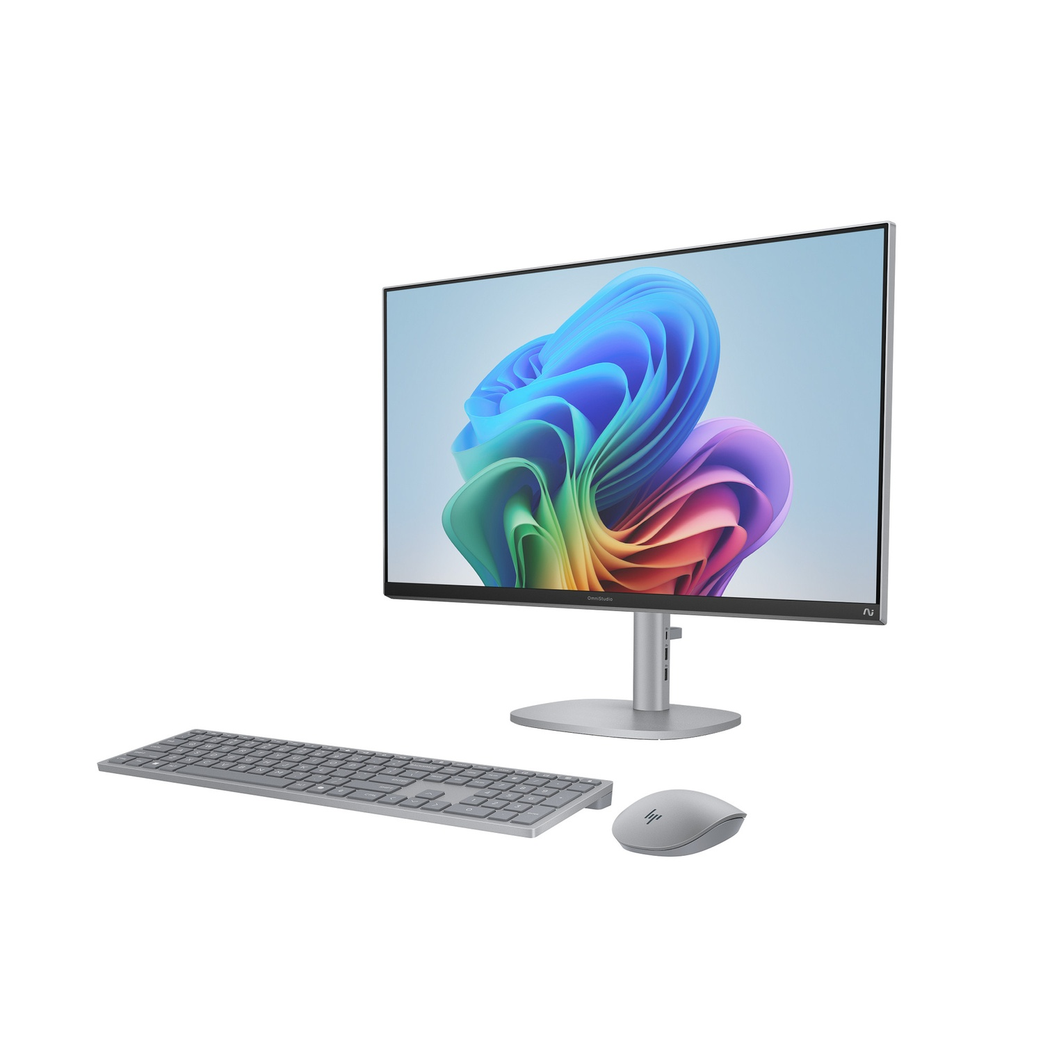 Une configuration d'ordinateur de bureau avec un moniteur affichant des formes abstraites colorées. Un clavier et une souris sont sur le bureau.
