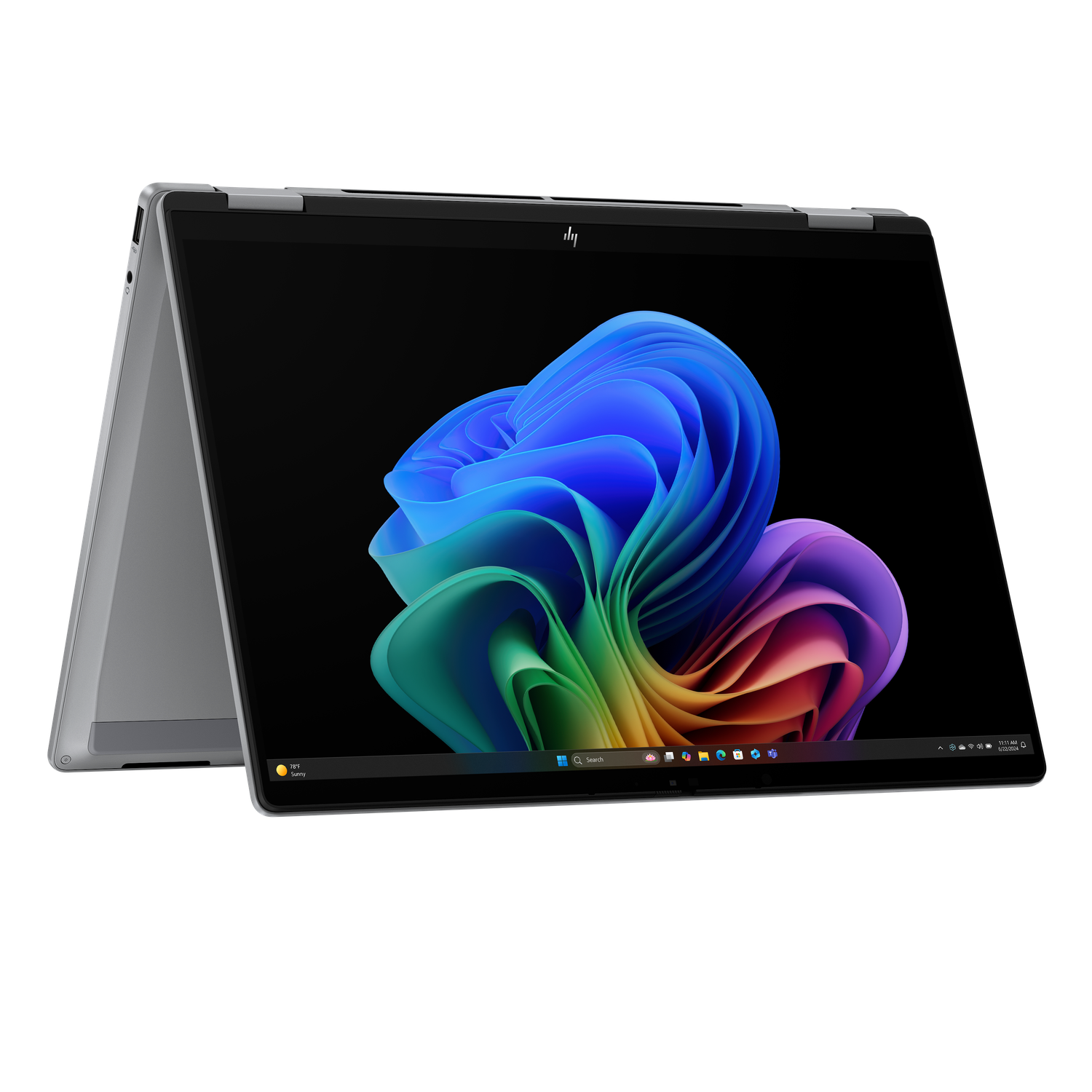 A silver HP laptop is open, displaying a colorful abstract swirl on the screen. The background is black.
