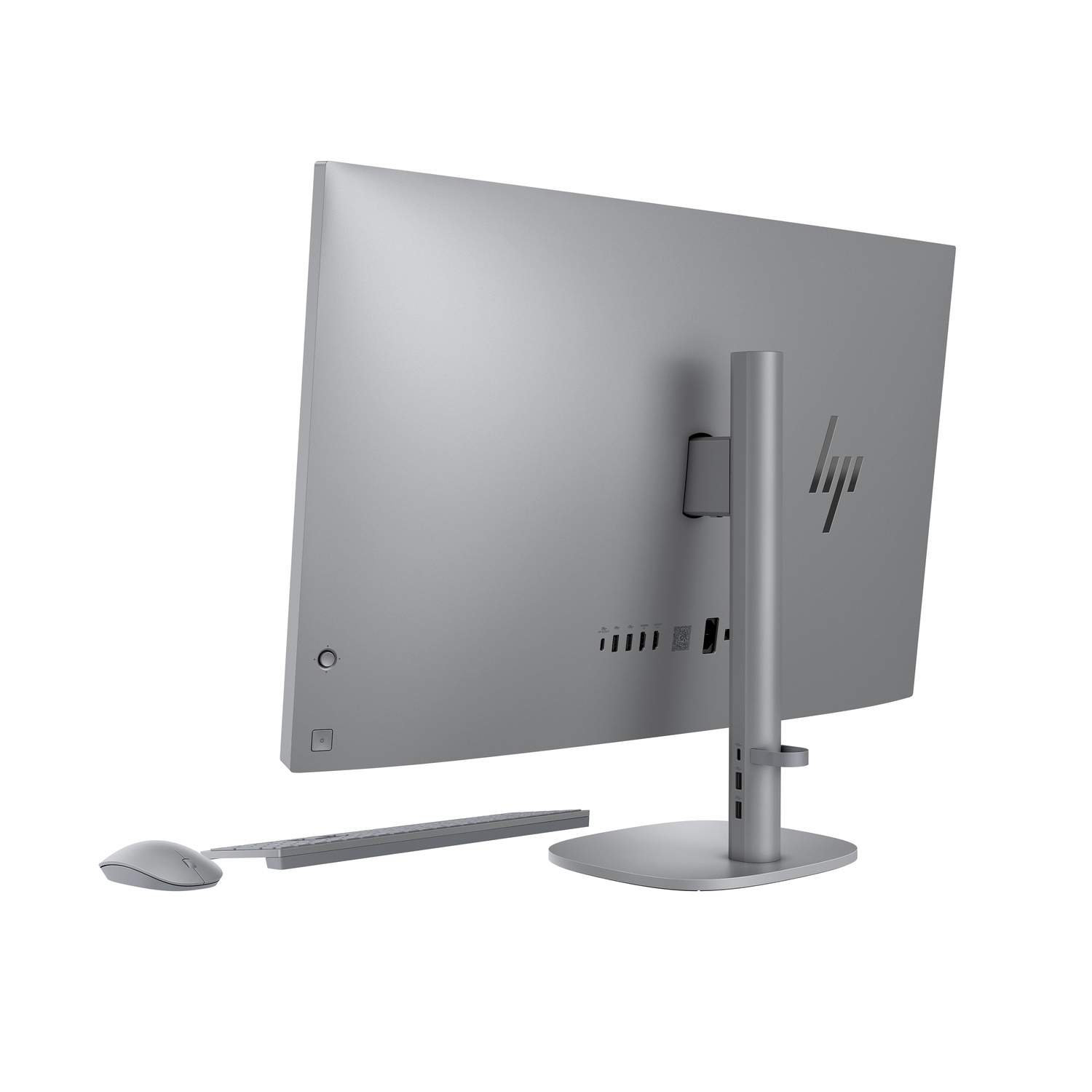 Een zilveren HP all-in-one computer van achteren gezien. Het bevat een monitor, toetsenbord, muis en standaard, allemaal zilver.