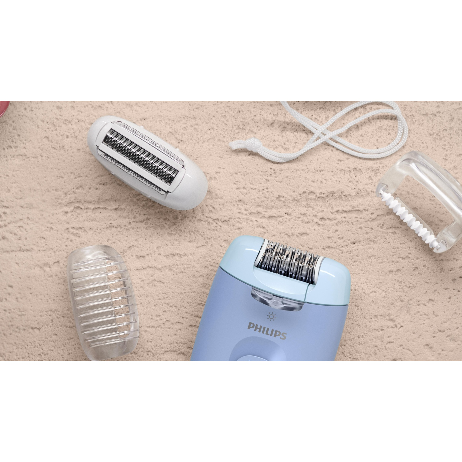 An overhead shot shows a blue Philips epilator with accessories. A white epilator head, a white cord, and clear plastic attachments.