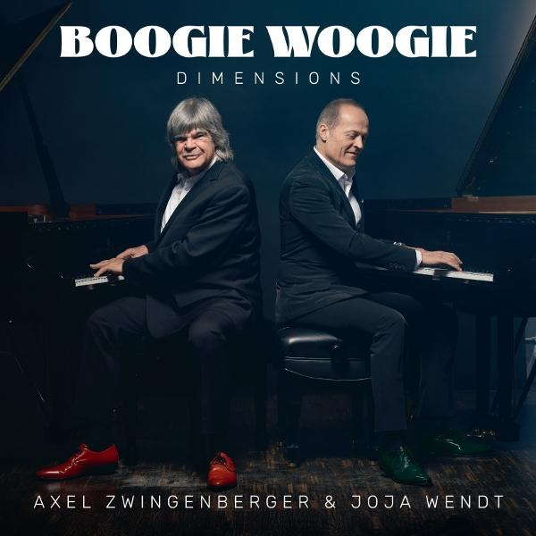 Zwei Männer sitzen am Klavier und spielen. Der Titel lautet „Boogie Woogie Dimensions“. Einer trägt rote Schuhe, der andere grüne.
