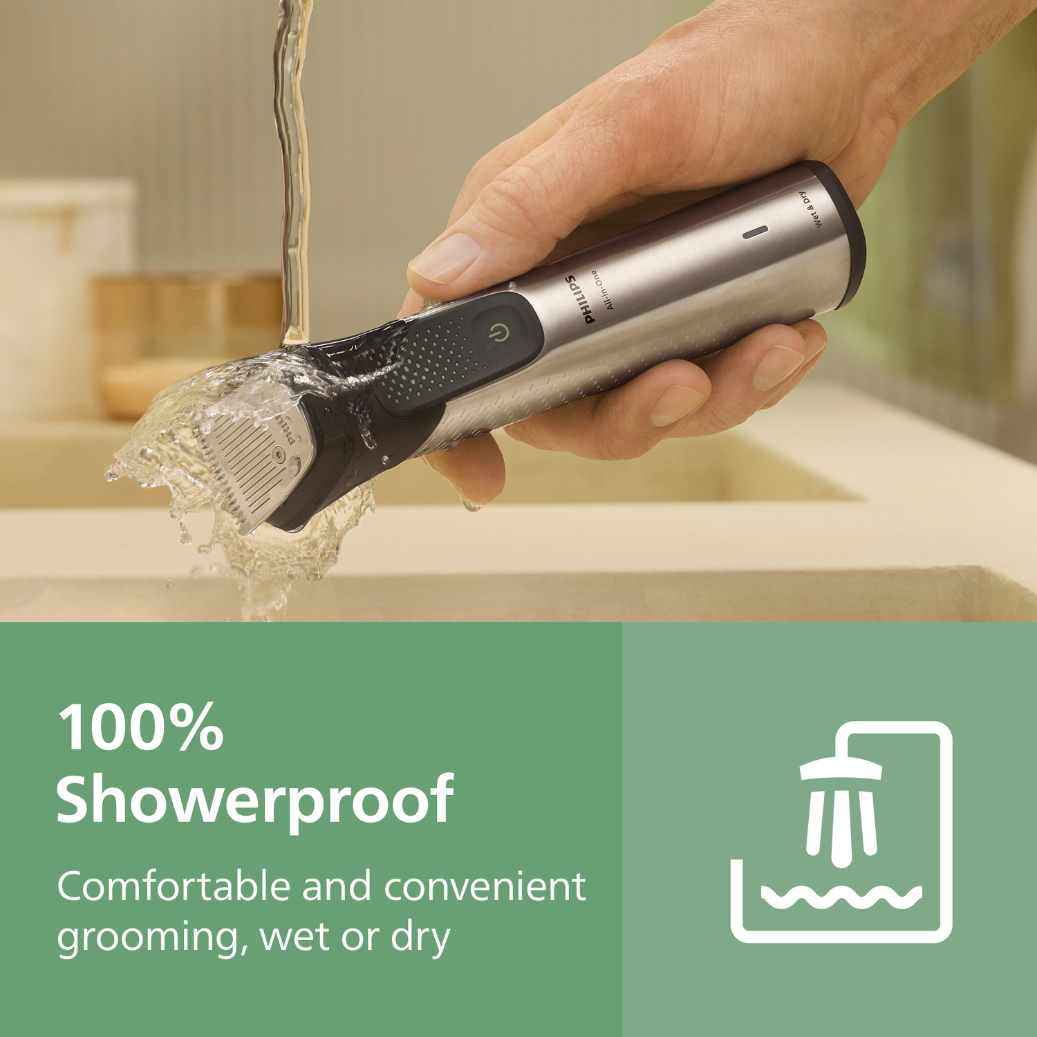 A person holds a Philips shaver under running water. The shaver is silver and black. Text says '100% Showerproof, comfortable grooming'.