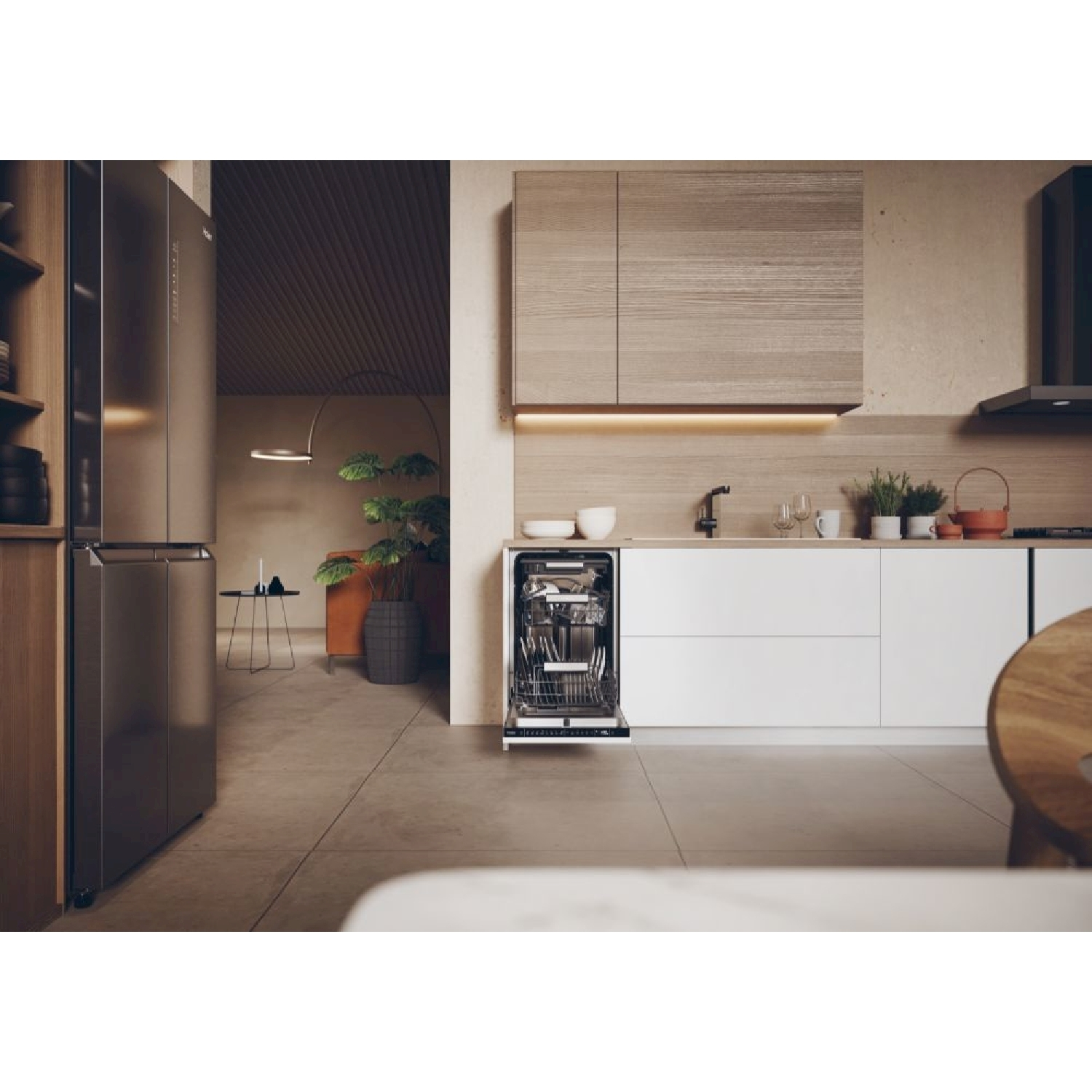 Cucina moderna con lavastoviglie aperta, frigorifero in acciaio inox, armadi in legno e una pianta. Tonalità neutre e design elegante.