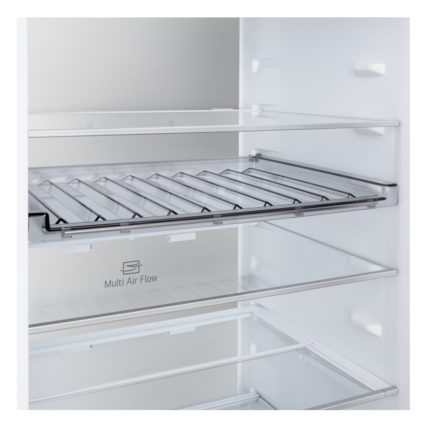 Inside of a refrigerator. There are glass shelves and a metal rack. The back wall has a Multi Air Flow logo.