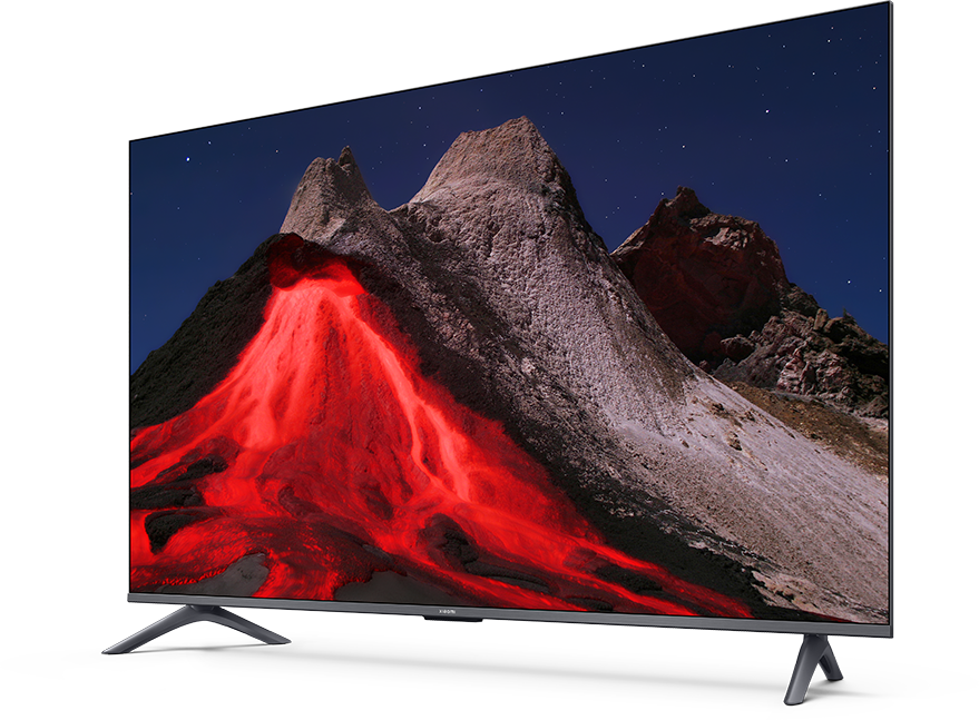 A TV-képernyő egy hegyi jelenetet jelenít meg vörös lávával, sötét éggel és csillagokkal. A TV sötét kerettel és szürke lábakkal rendelkezik.