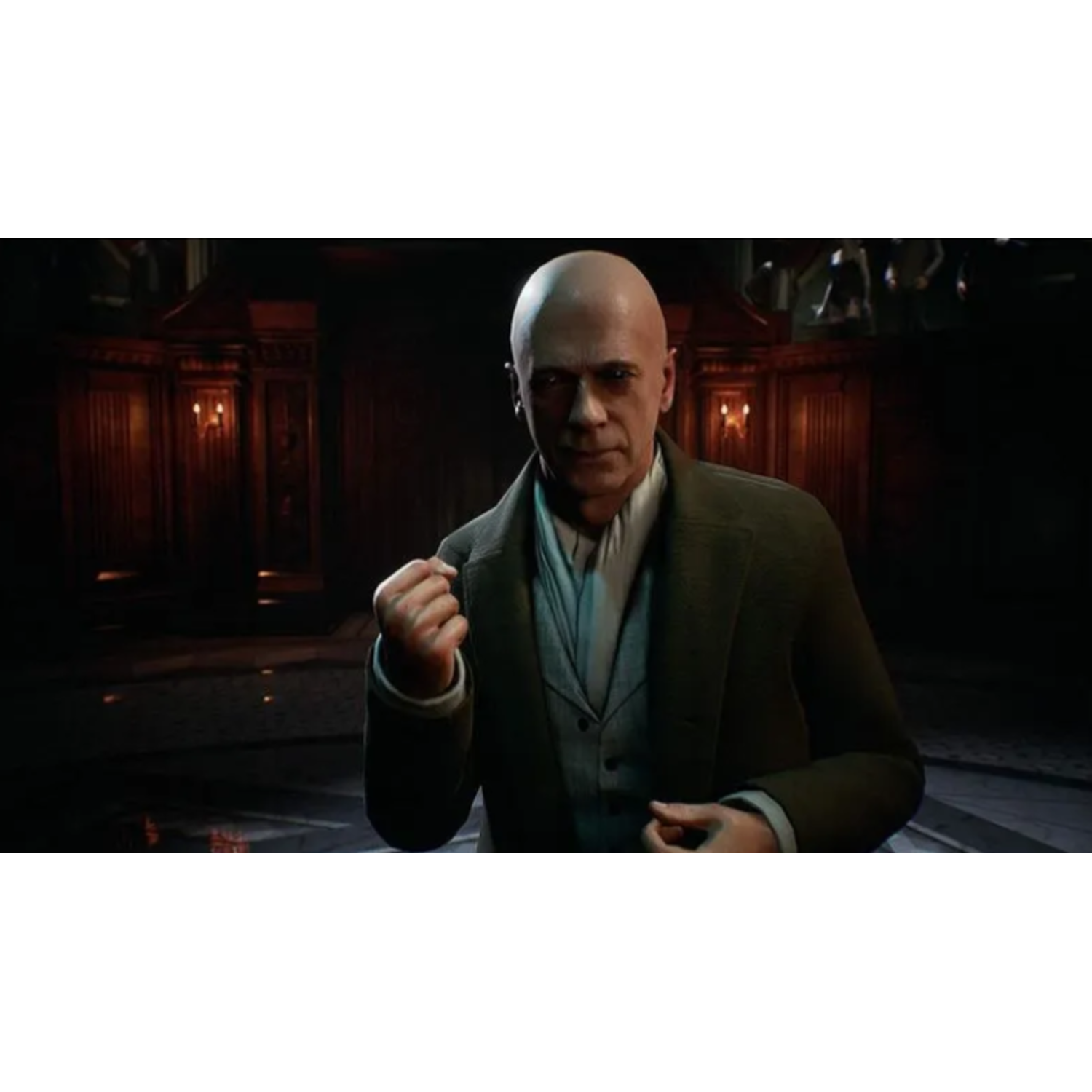 Bald man in a dark suit, with a clenched fist, stands in a dimly lit room with wooden panels. Other figures are in the background.