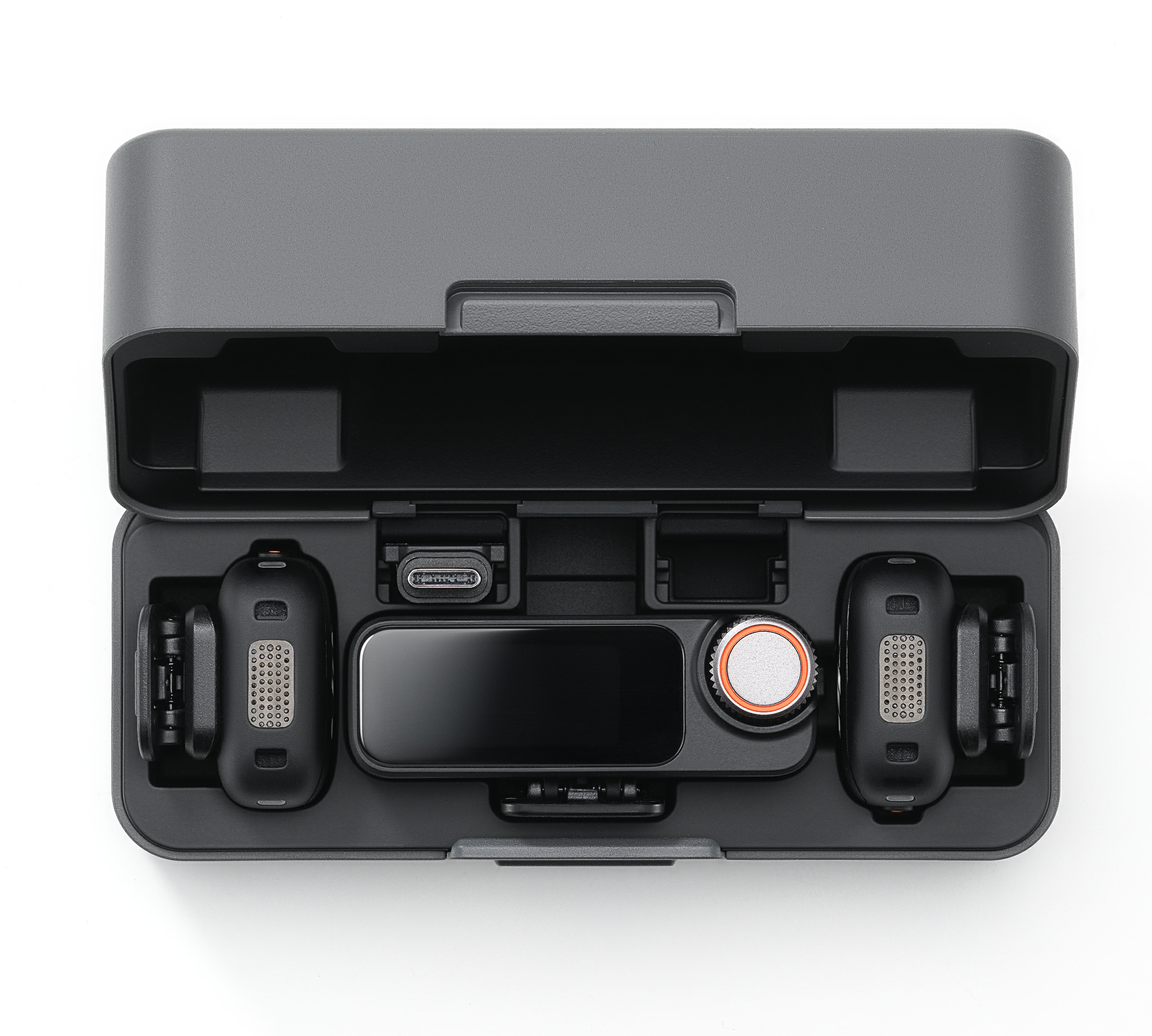 Szara obudowa zawiera czarną technologię. Zawiera ekran, dwa urządzenia, port USB-C i pokrętło z pomarańczowym pierścieniem.