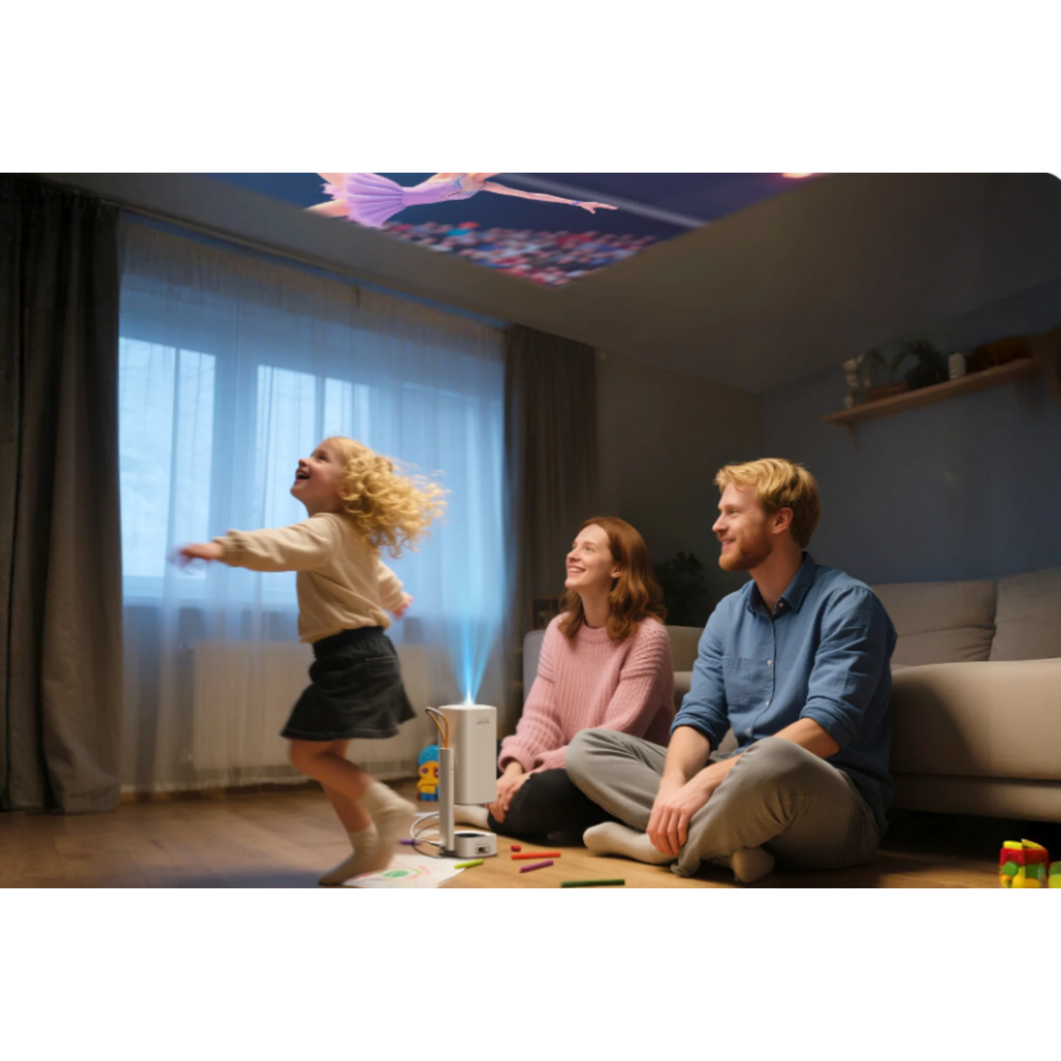 A family watches a projection on the ceiling. A girl jumps excitedly. Parents smile. Projector and crayons are on the floor.