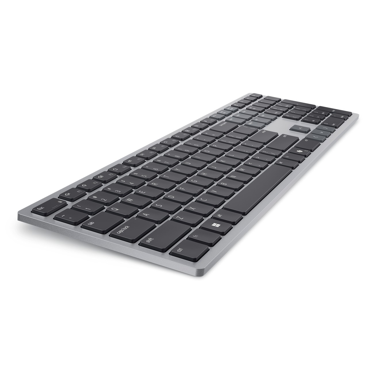 Eine silberne und schwarze Computertastatur ist auf einer weißen Oberfläche abgewinkelt. Die Tasten sind schwarz, der Rahmen silber.