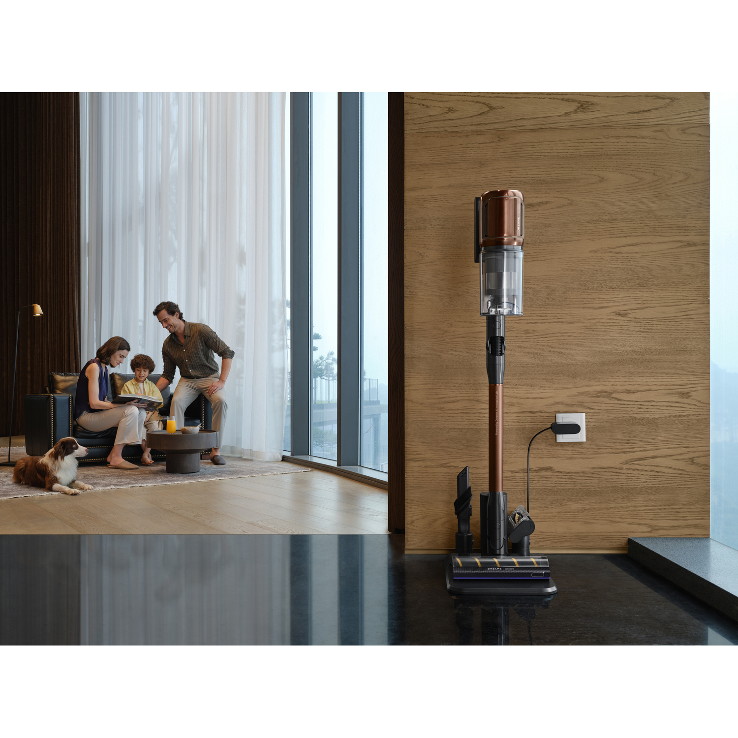 A family is in a living room with a vacuum cleaner. The vacuum is charging. A dog is on the left. The family is on the left.