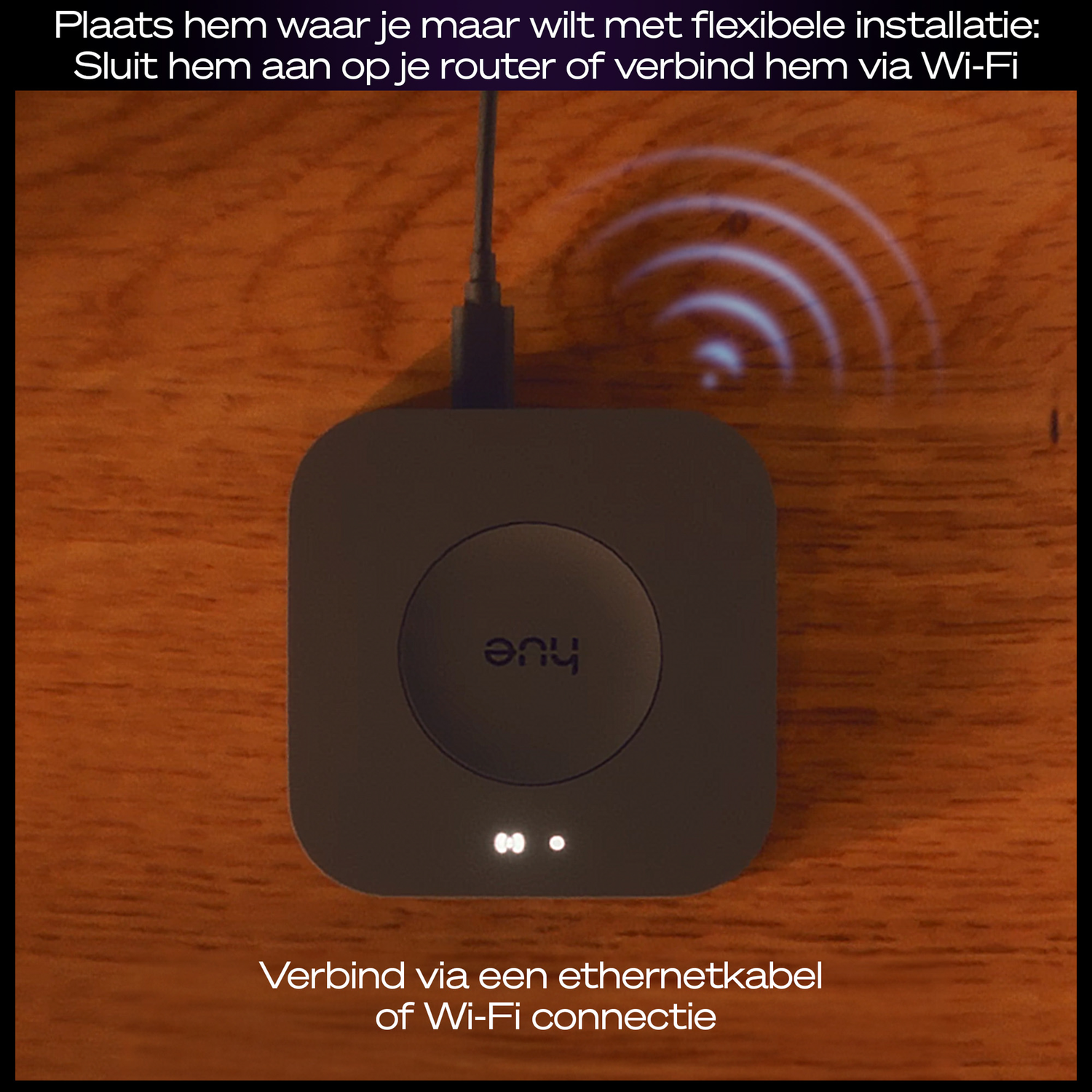 A black device with the word 'hue' is on a wooden surface. A cable is plugged in. WiFi symbol is visible.