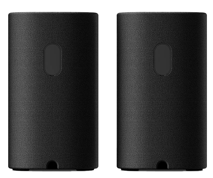 Dwa czarne głośniki cylindryczne z fakturą tkaniny. Każdy ma owalny przycisk. Tło jest białe.