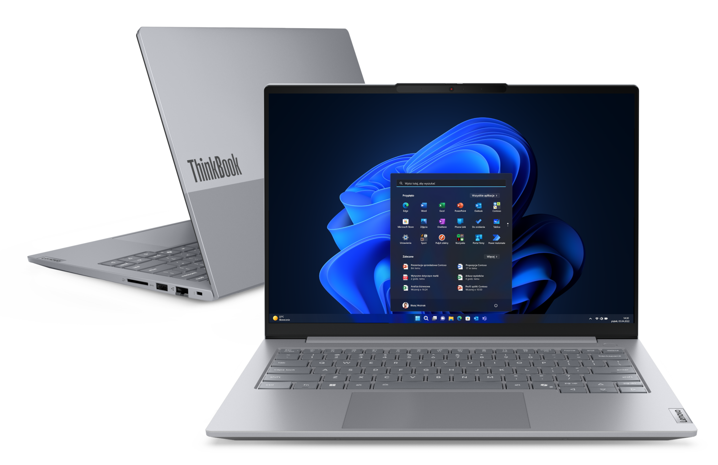 Srebrny laptop ThinkBook, otwarty, aby wyświetlić interfejs Windows 11. Drugi laptop jest częściowo widoczny w tle.