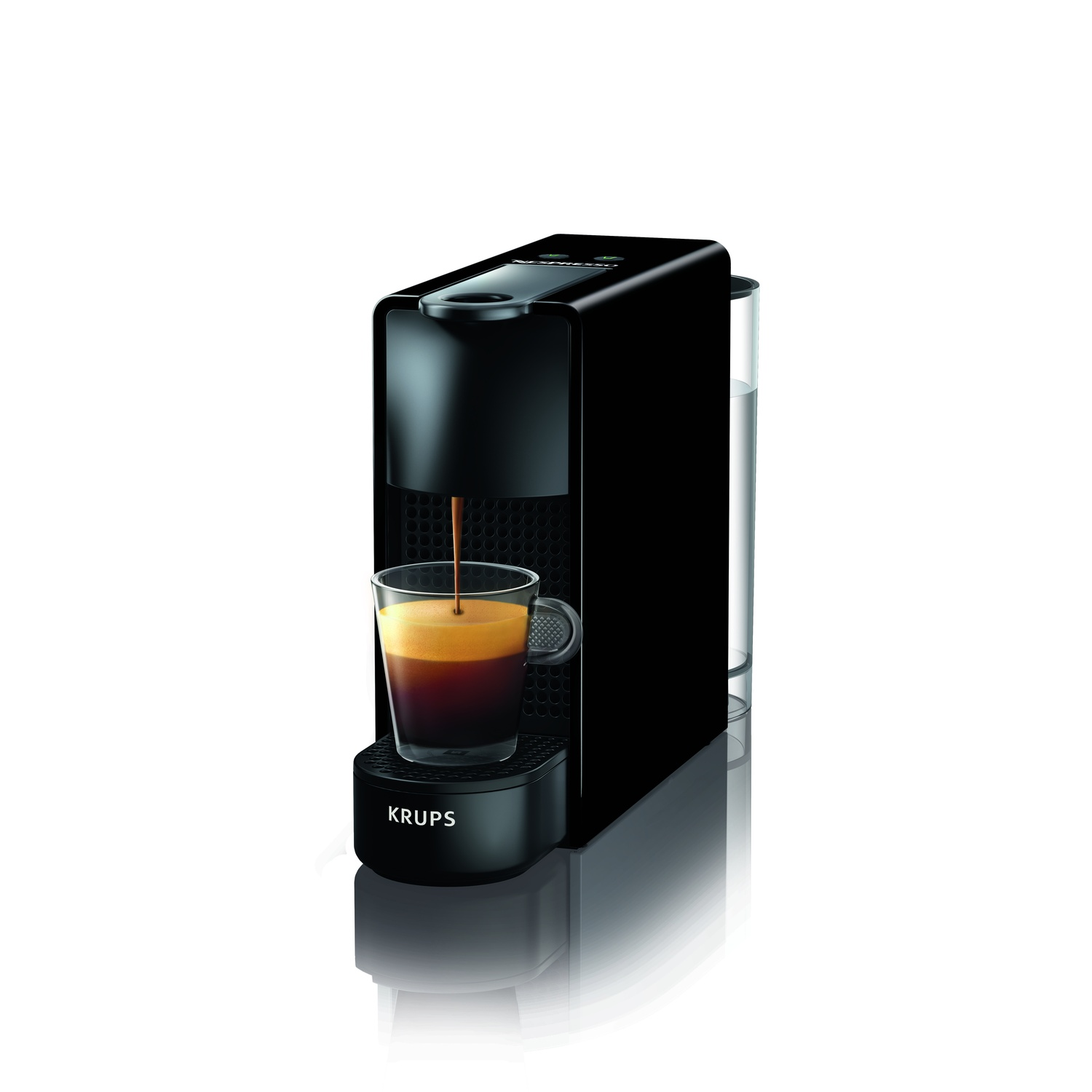 A black Krups coffee machine is dispensing coffee into a glass cup. A water container is on the side. White background.