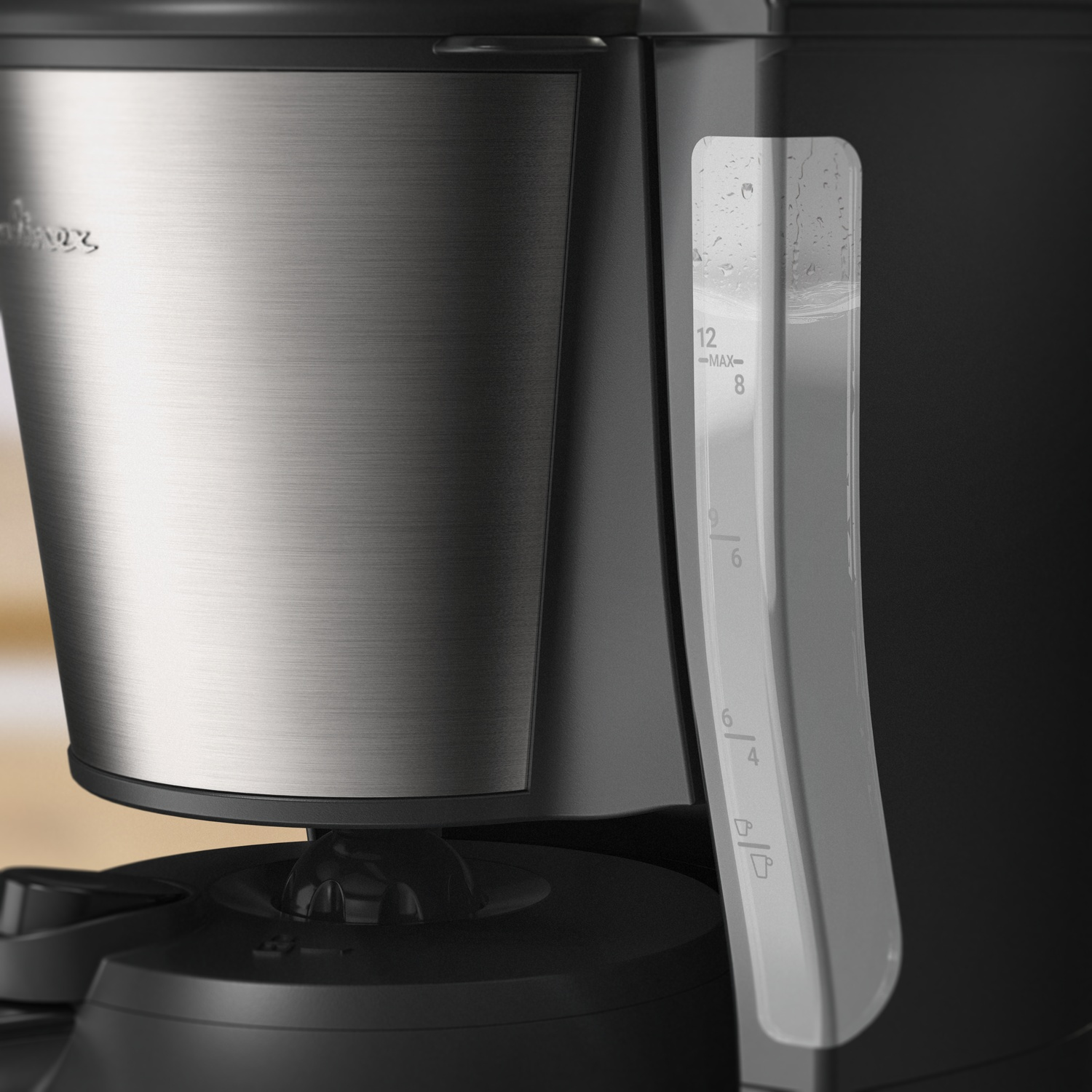 Close-up of a coffee maker. Stainless steel front, black accents. Water level indicator shows water. Numbers indicate cup levels.