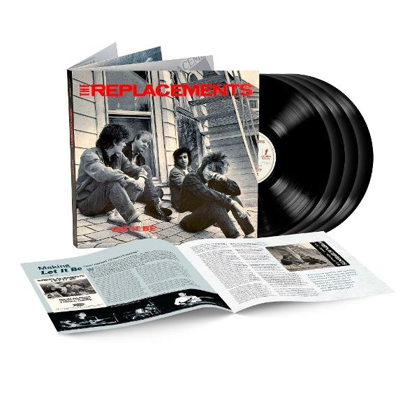 Albumcover und Schallplatten. Das Cover zeigt Bandmitglieder auf einem Dach. Offenes Booklet unten. Schwarze Platten rechts.