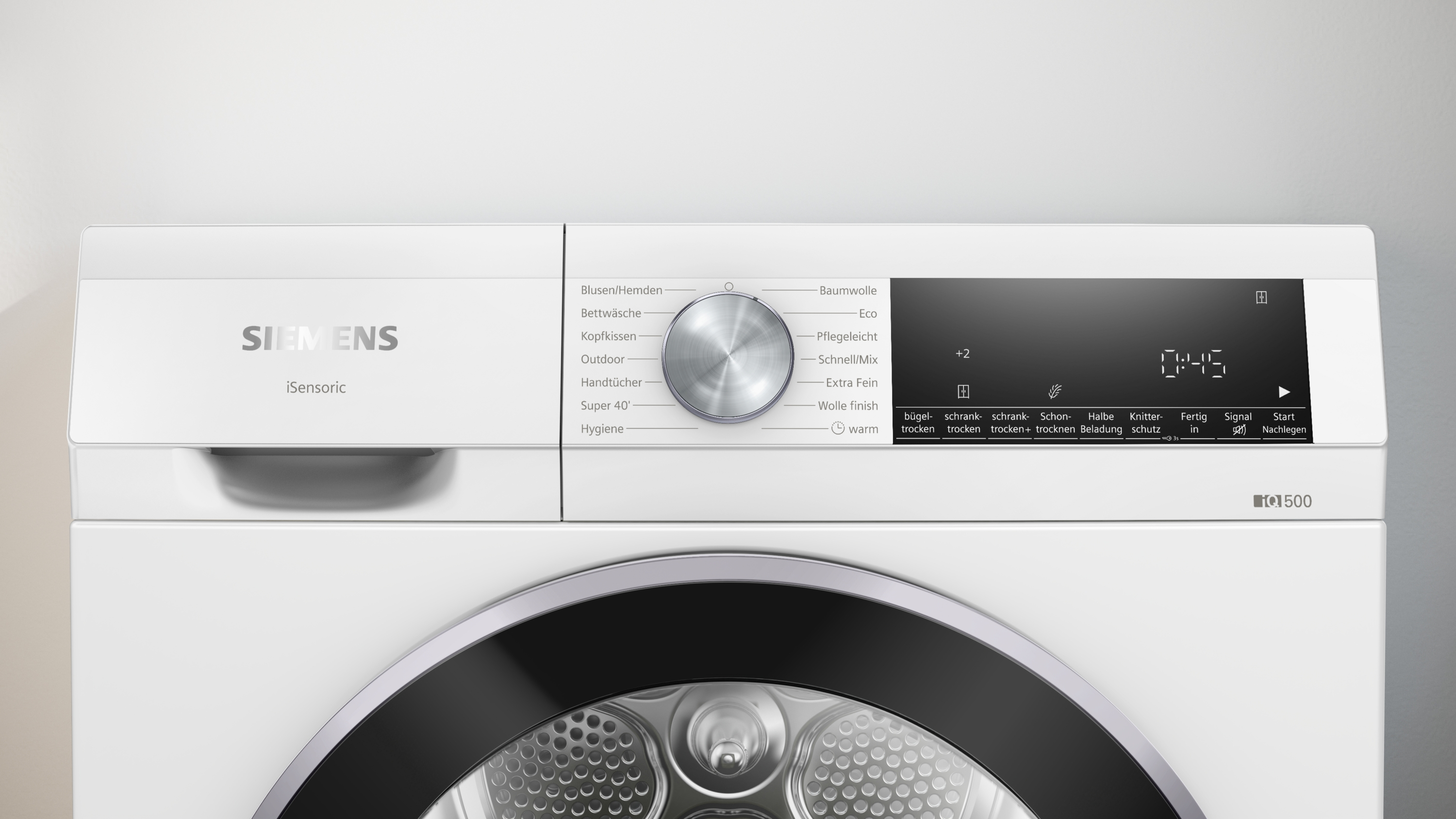 Weiße Siemens-Trocknerfront. Mit Bedienfeld und Digitalanzeige. Am Boden eine runde Tür.