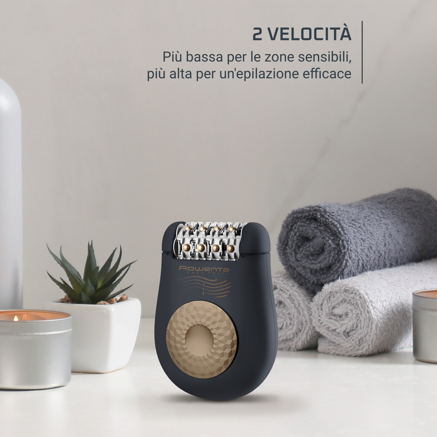 Un epilatore è su una superficie bianca, con asciugamani e una piccola pianta. Il testo in alto dice "2 VELOCITÀ".