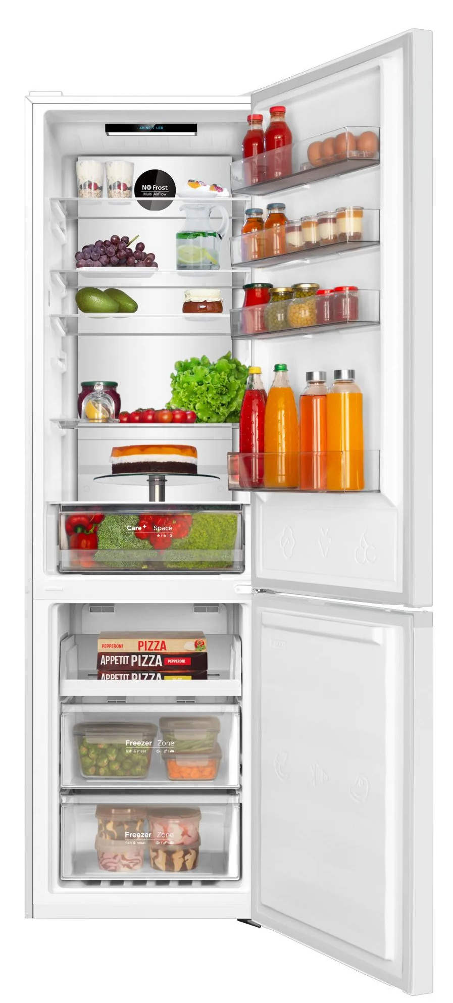 Otwarta lodówka wypełniona jedzeniem. Widoczne owoce, warzywa, soki i pizza. Zamrażarka znajduje się na dole.