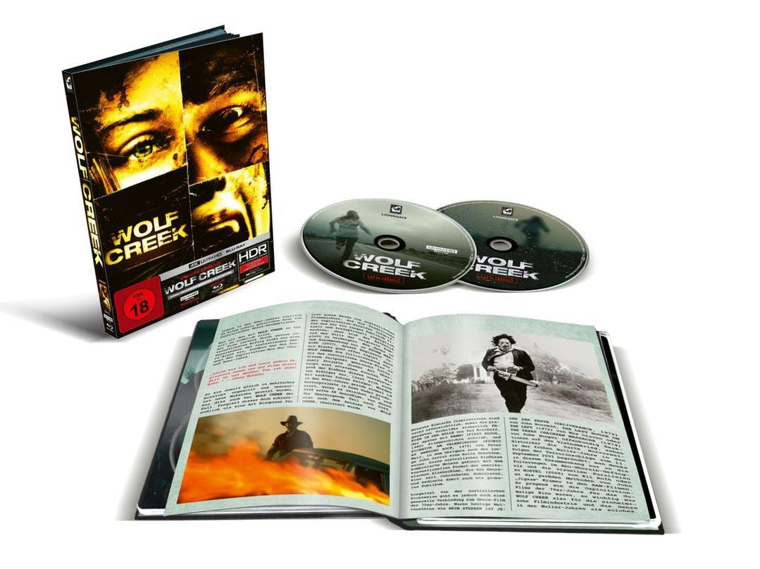 Ein Wolf Creek Blu-ray-Set. Enthält ein Buch, 2 Discs und eine Hülle. Das Cover zeigt Gesichter aus dem Film. Das Buch zeigt Filmbilder.